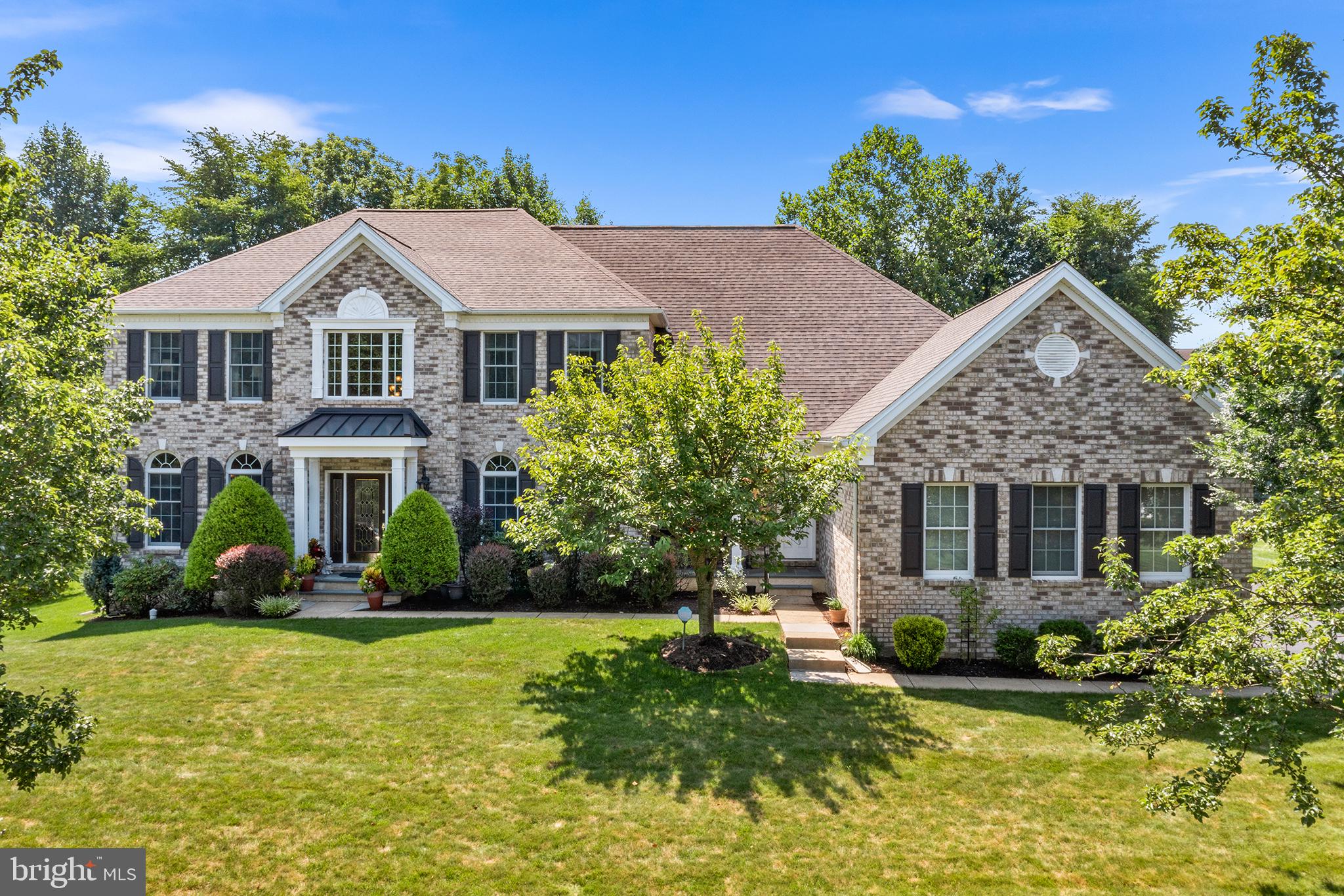 Welcome to 6 Hudson Way, a stunning Center Hall Colonial located in the spectacular neighborhood of The Reserve at Garnet Valley which offers custom-built homes within the Award-Winning Garnet Valley School District. This high-end residence boasts over 6,000 sq. ft. of total living space, including 6 spacious bedrooms—5 of which are en-suites with their own bathroom, toilet, and sink—and 6.5 bathrooms in total.
The home’s full brick front with Hardie plank siding exudes elegance and durability. As you step through the front door into the impressive two-story foyer, flanked by formal living and dining rooms, you’ll immediately notice the beautiful hardwood floors that flow throughout the entire main floor. The dining room with butler’s pantry leads through to the sunken great room, complete with a cozy fireplace and tons of natural light.  A private, elegant home office with double French doors and bay window next to a powder room can also be found on this side of the home.
The heart of the home is the stunning eat-in gourmet kitchen with a solarium overlooking the gorgeous backyard and deck. From stainless steel appliances to the large center island this space is perfect for entertaining.  Lastly, a convenient mudroom entrance with expanded laundry room, pantry storage and garage access can be found here.
The massive primary suite is a spectacular oasis, featuring a large walk-in closet and a sitting room with a double-sided fireplace shared with the impressive en-suite.  A unique and ideal primary bathroom includes a soaking tub, double occupancy dual-headed shower, double water closets and double sinks so no one has to share. Each additional bedroom is large, bright, and includes its own private bath, ensuring comfort and privacy for everyone.
The basement, finished by the esteemed Hellings Builders,  is a magnificent space, offering 2,200 sq. ft. of additional living area. It includes a primary bedroom with en-suite bath, a second bedroom, a fully equipped kitchen, another full bathroom, a surround sound system with Bose speakers, laundry facilities, and a private entry with storage.  This space has everything a guest, au-pair or extended family guest could possibly want.
Outside, the home is situated on a 0.5-acre level lot that is fully landscaped and sprinklered. The backyard is a serene setting with mature trees, greenery, and flowers surrounding you. Enjoy outdoor living on the 24' x 25' composite deck with a pergola and hardwired lights on all posts. Additional features include a large three-car garage and an efficient sprinkler system.
Located in the Garnet Valley School district and close to tons of shops, restaurants and green space of Glen Mills and surrounding towns. This home combines luxury, comfort, and functionality in a truly remarkable setting. Don’t miss the opportunity to make this exceptional property your own!