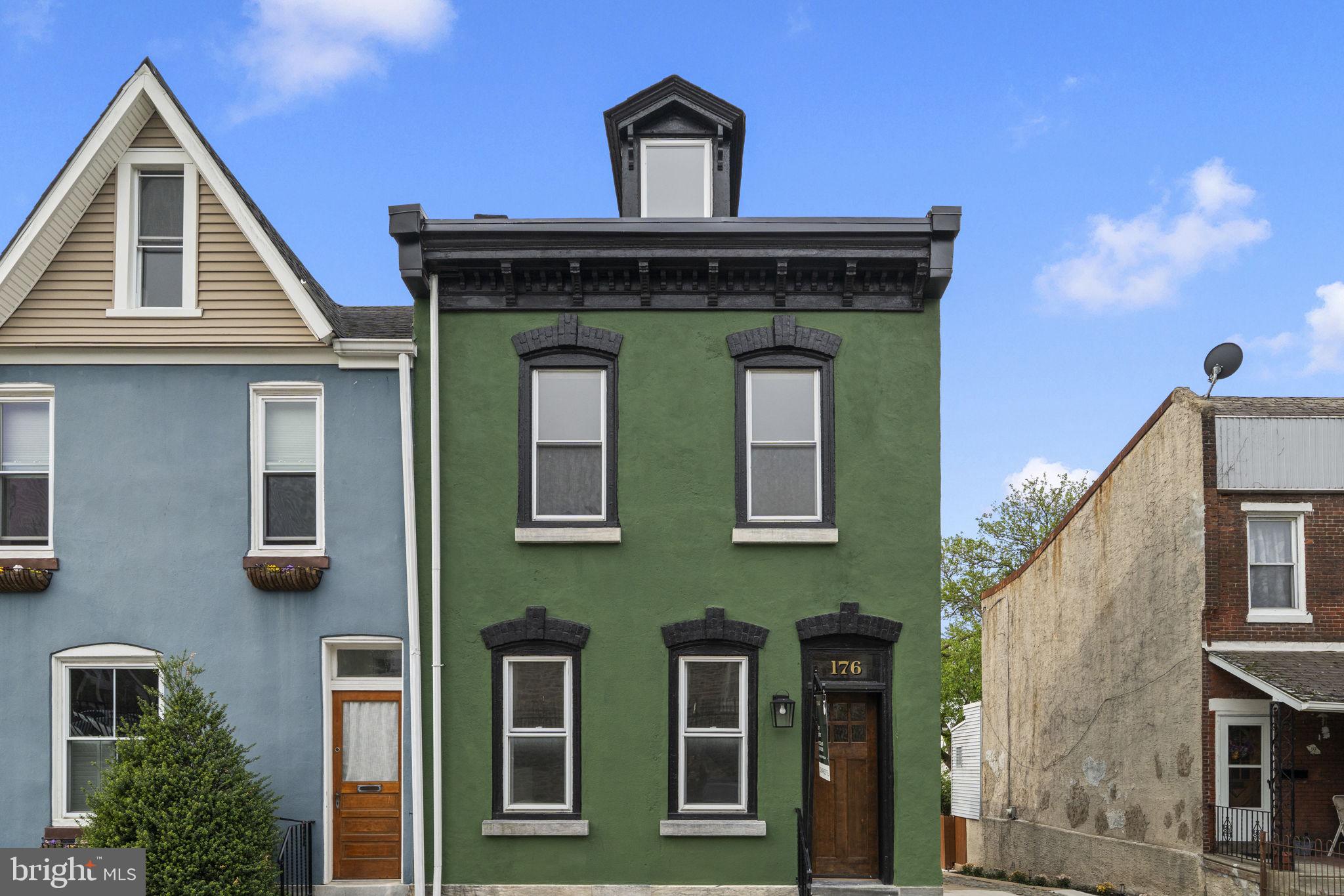 Welcome to 174–76 Lauriston Street, a captivating 4-bedroom, 2.5-bath end-of-row home in the highly sought-after Wissahickon section of Philadelphia, complete with off-street parking and an oversized detached garage with electric. This beautifully updated home with almost 2,000 total square feet offers the perfect blend of character, modern upgrades, and functional living space. Step into the inviting front living room featuring a cozy electric fireplace and brand-new hardwood flooring that flows seamlessly into the sunlit dining room with charming built-in storage. The fully renovated kitchen is a true showstopper, designed for both everyday living and entertaining, with a center island, 5-burner gas range with pot filler and vented hood, stylish tile backsplash, abundant cabinetry, and a skylight that fills the space with natural light. A convenient first-floor powder room, laundry, and direct access to the side porch complete this level. The second floor offers two generously sized bedrooms and a full hall bathroom, while the third floor is dedicated to a private primary retreat featuring stunning rear views of the Philadelphia skyline. The fully finished basement expands your living space with a versatile sitting area, wet bar (including a sink, faucent, and beverage refrigerator), full bathroom with soaking tub, and a fourth bedroom- perfect for guests, a home office, or additional living quarters. Outdoor living is just as impressive, with a covered side porch, with its own heater, ideal for relaxing or entertaining, plus a spacious backyard ready to be transformed into your own private oasis- whether a garden, patio, or play space. Ideally located just minutes from Kelly Drive, Main Street Manayunk, Wissahickon Valley Park, local universities, major highways, and SEPTA regional rail and bus lines, this home offers the perfect balance of convenience and lifestyle. Schedule your private tour today and experience everything this exceptional home has to offer!