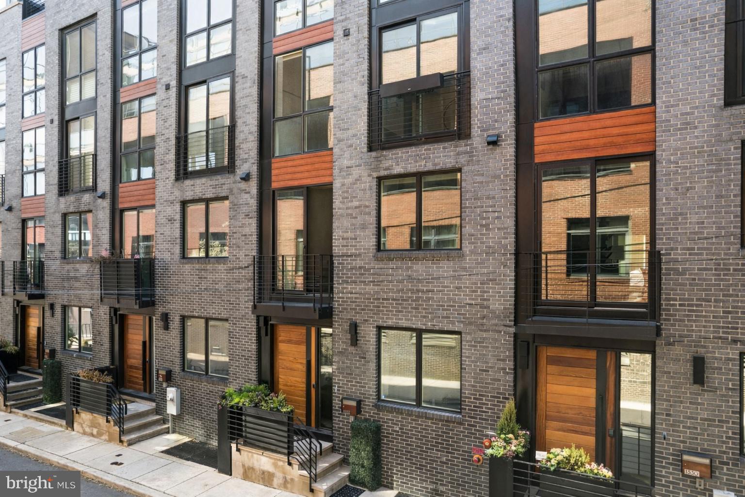1328 Kater Street is an exceptional, expansive luxury townhome — a rare opportunity to own a home of this scale, design, and finish, with 3 years remaining on the tax abatement. Beautifully decorated and impeccably presented, the home delivers an immediate wow factor from the moment you step inside. Generous proportions, soaring ceilings, and wide plank wood floors create an open, airy feel throughout, while thoughtful architectural design and curated finishes give every space a polished, elevated look. An in-home elevator provides seamless access to every level, adding both convenience and long-term livability.

The home offers 4 bedrooms, 3 full baths, and 3 half baths, with incredible flexibility across every level. The chef’s kitchen is a true standout, featuring Wolf and Sub-Zero appliances, handcrafted cabinetry, a stunning backsplash, and statement lighting that anchors the space. An elegant fireplace warms the main living area, while electric blinds from Allure are installed throughout, adding both convenience and a clean, modern finish. The home is also equipped with a Russound whole-home audio system, with built-in speakers throughout — including the primary bedroom and bath — creating a seamless, elevated sound experience across multiple levels.

Outdoor living is just as impressive. Multiple outdoor spaces include beautifully planted decks, a charming terrace off the main living area with a grill, and a spectacular upper deck with a retractable pergola — all coming together to create a private, resort-like setting ideal for both relaxing and entertaining.

A flexible entry-level living space with a half bath and large window overlooking the serene street is ideal for a home office, lounge, or additional living area. The primary suite is a true retreat, complete with two custom walk-in closets, incredible natural light, and a spa-like bath featuring a soaking tub, oversized glass shower, and Waterworks fixtures. Two additional large bedrooms offer generous space and flexibility, while closet space throughout the home is extensive and thoughtfully built out.

The top floor adds even more versatility with a bonus den, wet bar, and fireplace — an ideal space for entertaining or unwinding. A massive finished basement offers incredible additional living space, easily accommodating a home gym, playroom, or even a fourth bedroom. The rear portion has been thoughtfully prepared as an entertainment or theater-style media room with built in speakers and an audio system. With a full bathroom featuring a walk-in shower and ample storage throughout, the space also functions seamlessly as a guest suite, private retreat, or flexible living area.

A two-car garage and gated parking within a central courtyard complete the home with unmatched convenience. Set on a peaceful, tree-lined street in a private enclave that feels tucked away yet is just steps from neighborhood favorites, this home offers the best of both worlds — quiet, refined living with easy access to everything. Homes of this size, finish, and quality rarely become available — a truly special opportunity.

A major transformation is set to begin on South Broad Street later this month, marking the start of a 10-year, $150 million greening initiative that will introduce more trees, expanded green space, and a refreshed streetscape to one of Philly’s most iconic corridors.