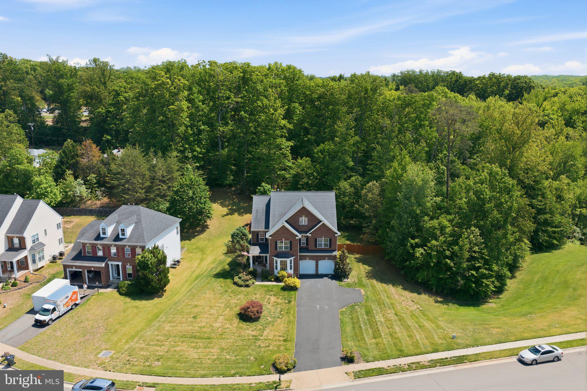 Welcome to  Historic Triangle Community in Lionsfield Valley, ideally located in close-in Triangle! Just minutes from MCB Quantico, I-95, &  Virginia Railway Express, this spacious colonial nestled in a quiet cul de sac. This extraordinary brick-front Stanley Martin “Bremar” model, is an  expansive four-level fully finished luxury residence located in  highly sought-after Lionsfield Valley community of Triangle. Perfectly situated on a private 1/2-acre cul-de-sac lot backing to serene woods w/ no neighboring homes on  left side, this stunning property offers  ideal blend of elegance, privacy, & functionality w/ 6 bedrooms & 5.5 bathrooms across four beautifully finished levels. From the  moment you arrive,  extended driveway w/ built-in turnaround, stately brick front exterior, & professionally designed landscaping create impressive curb appeal. Step inside to gleaming hardwood floors & an inviting open layout designed for both luxury living & entertaining.  grand foyer is flanked by elegant bay-windowed formal spaces, including a private office or den on right & a formal dining room on  left. Straight ahead,  expansive family room features hardwood flooring, a cozy gas fireplace, & seamless sightlines into gourmet chef’s kitchen.  kitchen is truly the heart of the home, showcasing a massive center island, abundant cabinetry, pantry closet, double wall ovens, built-in microwave, five-burner gas cooktop, designer stone backsplash, upgraded hood system, & newer Samsung refrigerator. French doors lead directly to  incredible outdoor entertaining area featuring a stamped concrete & stone patio w/ a built-in fire pit, creating  perfect setting for gatherings w/ family & friends while enjoying  peaceful wooded backdrop & surrounding wildlife. As you ascend  staircase, notice  upgraded metal railings & decorative balusters that add a sophisticated custom touch throughout  home.  upper bedroom level offers four spacious bedrooms, including an impressive primary suite complete w/ hardwood flooring, a private sitting area, gas fireplace, enormous walk-in closet, & luxurious spa-inspired bathroom featuring a corner jetted soaking tub, dual vanities, & an oversized walk-in shower w/ built-in seating.  2nd bedroom enjoys its own private en suite full bathroom, while  3rd & 4th bedrooms share a full bathroom.  The laundry room is conveniently located on  bedroom level for everyday ease.  4th level offers an incredible loft-style finished attic retreat featuring a massive recreation room, a full bathroom, & a spacious 5th bedroom, ideal for guests, multigenerational living, a private suite, media room, or additional flex space.  fully finished walk-up lower level continues to impress w/ expansive recreation areas, a dedicated gym setup, additional den ideal for an office or storage, & a true sixth bedroom complete w/ a large closet & its own beautifully updated full bathroom.  walk-up staircase provides convenient outdoor access while maintaining  privacy & functionality of  lower level.
Located just minutes from I-95, Route 234 commuter lot,  Quantico Front Gate, National Museum of  Marine Corps, shopping, dining, schools, & churches, this remarkable home offers luxury, convenience, & space in one of Prince William County’s most desirable communities. A rare opportunity to own a truly exceptional FOUR-LEVEL luxury home designed for comfortable everyday living & unforgettable entertaining. Vacation at home in this peaceful park-like setting near  Potomac River. Enjoy world-class shopping, dining, & entertainment at Stonebridge Potomac Town Center,  Rose Gaming Resort, Wegmans, & Potomac Mills Mall—all just a short drive away. An unbeatable commuter location: less than 5 miles to  VRE, w/ easy access to I-95, Route 1, MCB Quantico, Metro Bus, Park & Ride, & commuter options to Fort Belvoir,  Pentagon, & DC. Close to parks, Quantico hiking trails, & scenic Quantico Creek—your ideal blend of nature, comfort, & convenience awaits!