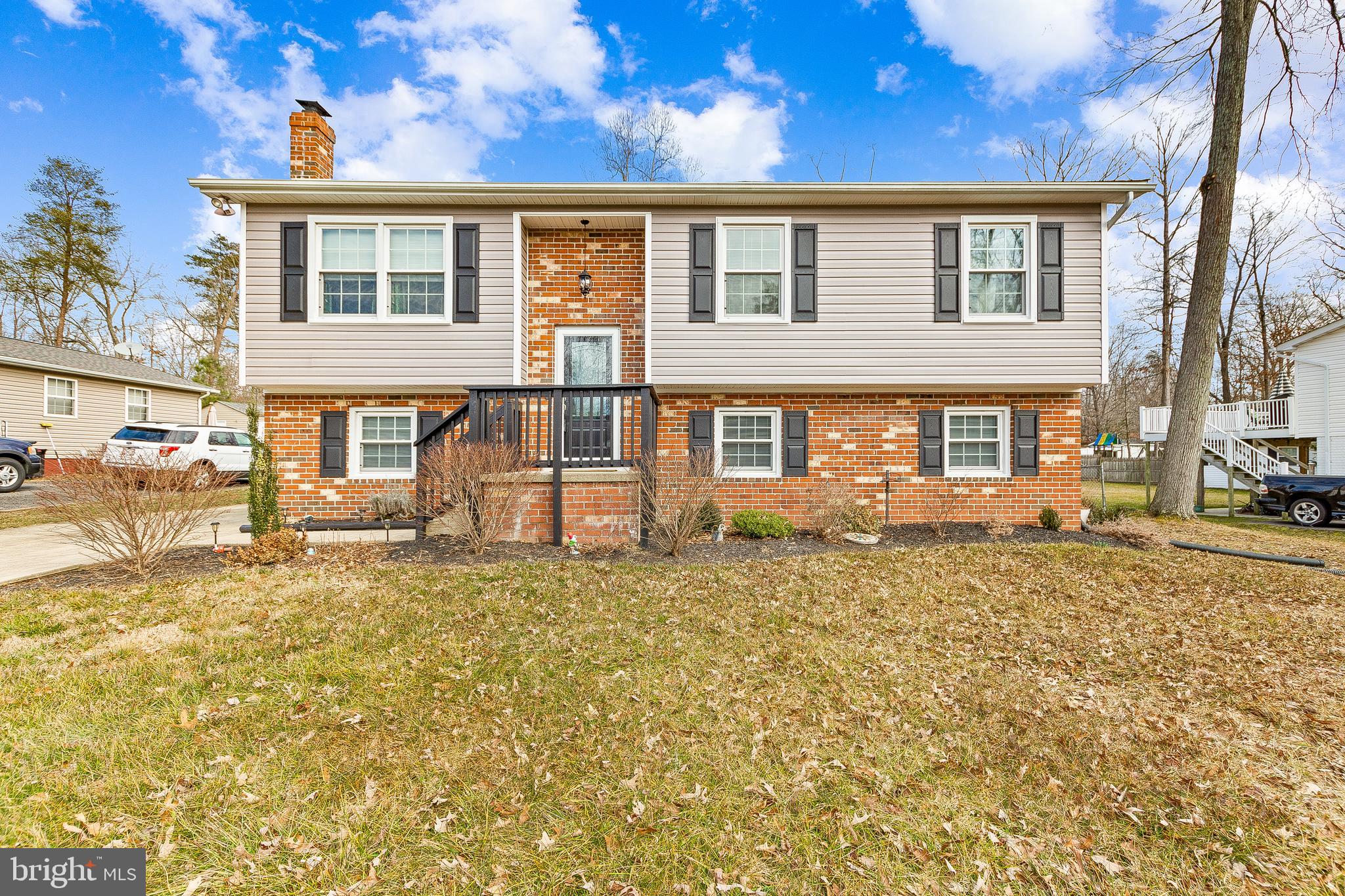 UPDATED & MOVE-IN READY !!! 3 Bed 2 Bath Split Foyer in Wicomico Shores. Brand new roof and siding has been installed! The newly replaced front door (2020) is a refreshing entrance into this must see home. The upper level greets you with hardwood floors and  a colorful living space that offers an immense amount of natural sunlight. The tiled open kitchen includes granite countertops and stainless steel appliances. Natural light spills into the connecting dining space from the sliding doors that overlook the large back deck (replaced 2020) and spacious, fenced in backyard. Head down the hallway to find the three bedrooms, all complete with closets and hardwood flooring. Their shared full bath w/ upgraded finishes completes the upper level. Head downstairs to a large open rec room that encompasses the entire lower level. Make this space your own with your entertainment or office needs alike! Sliding doors open onto the lower deck housing a perfect shady spot to lounge in the summer! The laundry room with a washer/dryer set included (replaced 2014) and full bath complete the lower level. The home is topped off with newly installed (2015) Tesla Solar Panel System (lease, must be taken over by new owner) that give this home a modern, eco-friendly feel. This home is a must see to check it out before it's gone!