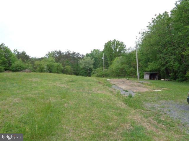 Beautiful 7.4 acres, ready to build on with well, septic & electric already in place. Partially wooded and private location.  There is a 1987 singlewide mobile home on property that needs repairs. Furnace is only a couple years old.  The seller, at seller's ezpense will remove mobile home.