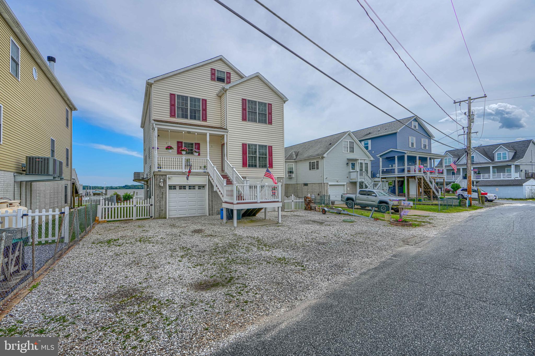 Experience the best of Chesapeake Bay waterfront living in this beautifully updated, move-in-ready 4-bedroom, 3-bath home offering approximately **50 feet of shoreline**, spectacular water views, and a private 120-foot pier. Designed for boating enthusiasts and anyone seeking the ultimate waterfront lifestyle, the marine-grade pier features **two boat slips**, a **10,000-pound boat lift**, and a separate lift for jet skis or other personal watercraft, providing direct access to the Chesapeake Bay for boating, fishing, crabbing, kayaking, and paddleboarding.

Thoughtfully designed for everyday living and entertaining, the home features **three spacious bedrooms and two full baths on the upper level**, including a private primary suite with a convenient **laundry chute** that leads directly to the first-floor laundry room. A **main-level full bath with shower** offers added flexibility for guests, rinsing off after a day on the water, or potential main-level living.

The updated kitchen is equipped with **GE Profile appliances**, including a modern **induction cooktop**, blending performance, efficiency, and style. Recent improvements include **two 3-ton HVAC systems (2023), GE Profile appliances (2023), a hybrid hot water heater (2025), new second-floor carpeting (2026), and beautifully refinished hardwood floors (2026)**, allowing buyers to move in with confidence.

Step outside onto the expansive **12' x 30' Trex deck**, perfectly positioned to enjoy panoramic water views, outdoor dining, entertaining, or peaceful mornings overlooking the water. Additional premium features include **400-amp electrical service**, ideal for today's technology needs and future upgrades, along with a **rough-in for a future elevator**, providing long-term flexibility and accessibility.

Whether you're searching for a **waterfront home**, **private dock**, **boat lift**, **deep-water access**, **Chesapeake Bay boating**, or a luxury waterfront retreat with modern updates and exceptional outdoor living, this remarkable property delivers an unmatched combination of comfort, convenience, and coastal lifestyle.