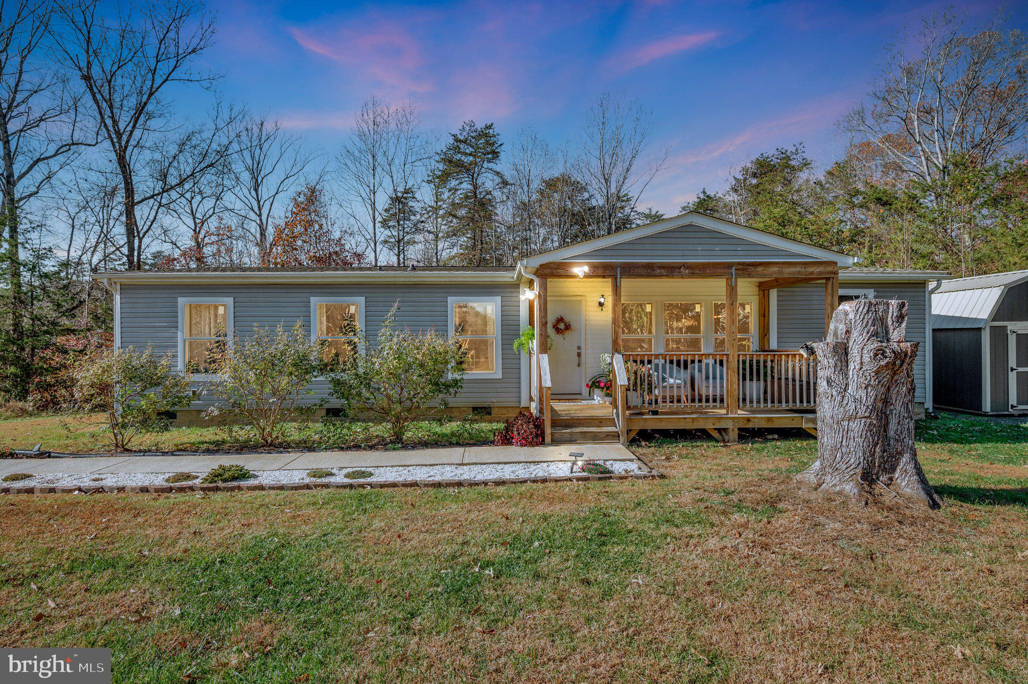 Built in 2022, this single-level home offers modern comfort on more than six acres in Rhoadesville, VA. It features three well sized bedrooms and two full bathrooms, with an open-concept center layout designed for everyday living. HIGH SPEED INTERNET. The main living area includes luxury plank vinyl flooring and a spacious design that connects the kitchen, dining, and living spaces. The kitchen offers a large center island with seating, ample counter space, and modern cabinetry, creating a functional area for meal preparation and gathering. The primary bedroom includes a private bathroom with updated finishes and a walk-in closet. Two additional bedrooms provide comfortable space for family members, guests, or a home office. A large covered front deck provides outdoor living space and views of the surrounding countryside. The home is situated on over six acres of open land, offering room for outdoor activities, gardening, or future improvements. This property is located within a short drive of Locust Grove, Culpeper, and Fredericksburg, providing access to shopping, dining, and commuter routes while maintaining a peaceful rural setting.