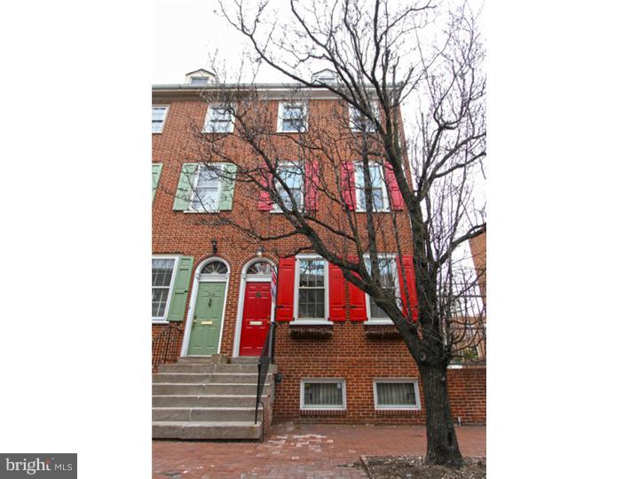 This stunning brick front property, with over 2,400 sf of space, has 3 bedrooms 2.5 baths, with 1 car deeded off street parking (parking space 1) and is located in Society Hill on the cusp of Washington Square West. This location speaks for itself being called a "Walkers Paradise" with a Walk Score of 97! The interior is equally impressive. Enter in to a marble tile foyer with cathedral height ceiling and to the right an enormous walk in closet with built in shelving. Step up to the loft style dining room that overlooks the family room below. 2 stories of the rear of this home has been transformed into an impressive 20+ft Glass Atrium with inspiring views of a private brick garden patio and open to sky views. This atrium can be enjoyed from the dining room as well as the family room below. Enter in to the contemporary kitchen through a beautiful Art Deco custom glass stained solid wood door. The kitchen features stainless appliances,5 burner gas range, modern glass tile back splash, a built in pantry with pull out drawers, and plenty of granite counters to work with. The lower level is an extremely large family room filled with natural light from the atrium  and there is a lovely wood burning fire place with a handsome marble base. The powder room and laundry room are also located on this level. You'll notice as you tour this home that there are recessed lights and hard wood floors in pristine condition throughout. The open solid wood staircase and iron stair rails will lead you up the the next level where 2 large bedrooms are separated by the shared bath. Each room has plenty of closets and there are even extra closets in the hall. The upper most level is the master bedroom suite. At the top of the stairs there is an open flex space, an Orchid Room with French doors, and roof top views. The master bath is located on this level as well and has a large vanity with dual sinks, granite vanity top, and a glass enclosed shower. The master bedroom facing Lombard includes built in cabinetry for storage as well as a walk in closet and hall linen closet. Amazing home in a fantastic location. Parking located to the immediate right of the home in the private parking lot.  Also, small park/garden down the cobblestone alley at the end of the row homes is uses by all the residents on the block.