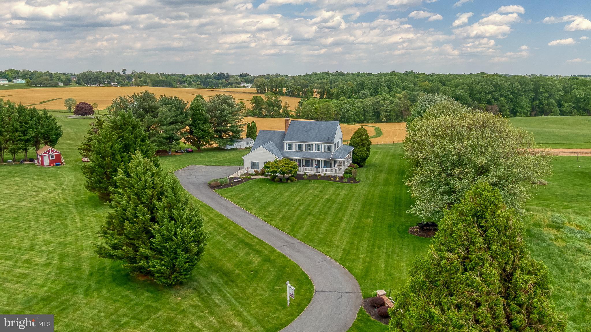 This stunning custom-built colonial on more than 2-1/4 acres offering amazing sunsets and views you won't forget. The main-level primary suite boasts a vaulted ceiling, walk-in shower, dual closets, and private access to the expansive rear deck. Enjoy outdoor living with a wrap-around covered porch and large maintenance-free deck and patio. The home features multiple bump-outs, including a bright sunroom off the kitchen with skylights. The kitchen is updated with granite countertops, backsplash, and luxury vinyl plank flooring. You'll find both a pellet stove and wood stove. Convenient main-level laundry and an oversized two-car garage provides ample parking, while a storage shed provides additional space. Upstairs offers four additional bedrooms, two full baths, and a versatile office or playroom. The finished lower level is an entertainer’s dream with a huge rec room, wet bar, and bathroom. There is farmland behind the house, where the crops alternate each season between soybeans and corn stalks. With its gorgeous setting and generous gathering spaces, this home has even hosted several weddings - truly a one-of-a-kind property.