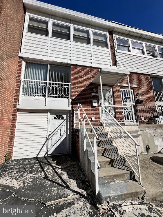 Welcome to this beautiful, traditional-style interior row townhouse located at 6926 Grosbeak Pl in Southwest Philadelphia. This 1965-built home features a classic brick and vinyl siding exterior with an inviting raised entryway. Boasting 1,296 square feet of finished living space, the home opens up into a spacious, light-filled environment illuminated by modern recessed lighting. The expansive living and dining areas showcase gorgeous new hardwood floors and elegant white wainscoting set against tasteful soft blue and neutral walls. This level flows seamlessly toward the modern eat-in kitchen, which comes equipped with gas cooking.  Upstairs, the home features three comfortable bedrooms, highlighted by stunning hardwood flooring and ample closet space. The full bathroom serves as a private oasis featuring tiled walls, a pedestal sink, and a large jetted soaking tub perfect for relaxing. Downstairs, the property includes a finished partial basement that provides extra functional space, a dedicated area for laundry and convenient interior access to the attached one-car garage. Complete with central air conditioning, natural gas heating, and a private backyard, this move-in ready home is a must-see.