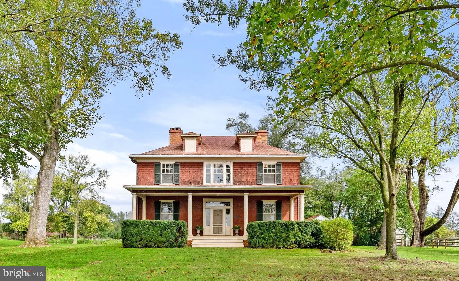 Offered for the first time, Abbeyville is a rare 146-acre estate in Clarke County, superbly located just outside Boyce. Built in 1909, this property provides unmatched versatility with additional dwelling unit rights and a multitude of possibilities—a private residence, equestrian estate, working farm, family enclave, or new build. With potential for limited subdivision and prime eligibility for land conservation programs and easement tax credits, Abbeyville presents an extraordinary opportunity. This Colonial Revival house is a living antique, rich in original features, perfect for anyone looking to own and restore a piece of history. Featured in "Clarke County, Virginia: History Through Architecture," Abbeyville is a classic example of American Foursquare design. The original front door opens to a spacious foyer, with the Dining room with fireplace on one side and the Living Room with mountain views and its own fireplace on the other—both can be enclosed with original pocket doors. The library, with built-in bookshelves and wood stove, offers an ideal retreat for reading or work. The main level is completed by a kitchen and half bath. Upstairs, three oversized bedrooms with fireplaces, two smaller bedrooms, and a full bath, offer ample space and potential. Outside, the rare wood shingle siding is complemented by a pressed-tin roof and two corbelled brick chimneys. The south-facing front porch spans the width of the house, perfect for relaxing or dining alfresco. Surrounding the house are open, rolling pastures, divided into 20- to 40-acre fully fenced fields. The barn provides storage and shelter for livestock. The western fields are currently used for grazing cattle, while the eastern fields, used for hay production, have scenic views. A 2-bedroom tenant house (#410 Old Winchester Rd), built in 1999 on the original spring house site, offers multi-generational living or rental income potential. Live the country life near historic estates like Long Branch, The Tuleyries, and Carter Hall. Host guests at nearby Villa La Campagnette. Play at the State Arboretum, Sky Meadows State Park, and the Shenandoah River—all within a 15-minute drive. Enjoy local restaurants, wineries, breweries, and golf courses with quick access to Rt 340, Rt 7, Rt 50 and I-81. Located 20 minutes from Winchester and Front Royal, 45 minutes from Middleburg, and just 90 minutes from Washington DC.