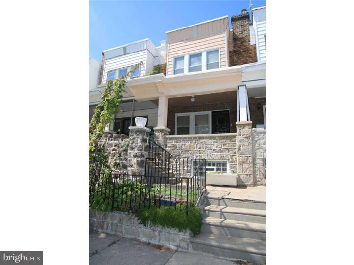 handsome house with stone foundation on one of the prettiest blocks in a the trendy Museum area, one block from the Eastern State Pen, numerous cafe and restaurants within walking distance. Nice size   garage plus and an additional parking space in the back with a driveway last and current legal zoning it is for 2 units (see attached document in sellers disclosure.   2  bedrooms in each floor currently configured as a duplex with two full baths and two kitchens.  dry finished basement with multiple rooms and laundry  Property being sold "as is"