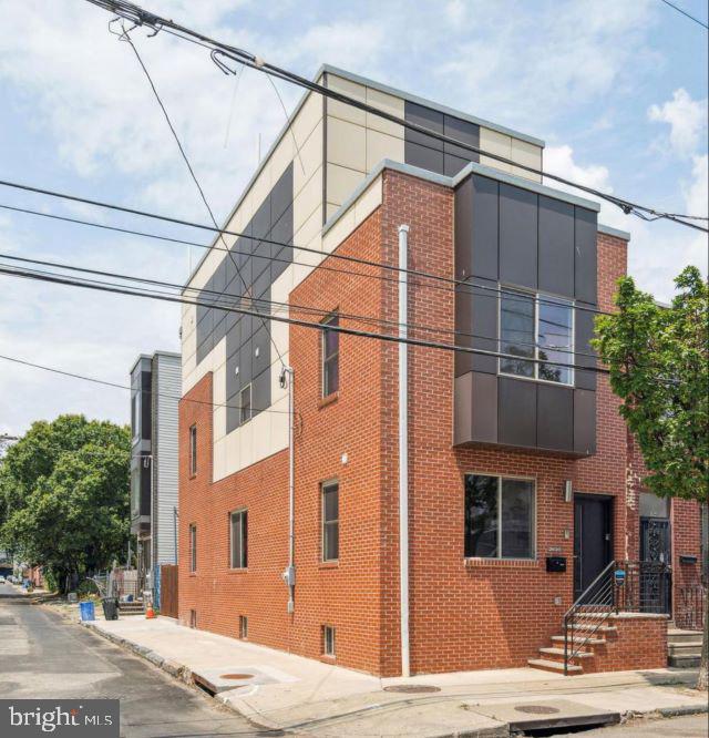 A striking corner residence where sophisticated design meets elevated city living — steps from the pulse of Frankford Avenue in the heart of 19125.
Bathed in natural light from its coveted southern exposure, this 3BR/3BA home commands attention with an expansive open-concept living and dining space built for both entertaining and everyday luxury.
The gourmet kitchen is a true showpiece — veined granite countertops, premium stainless appliances, a statement island with seating, built-in wine refrigerator, and soft-close cabinetry throughout. A private backyard retreat extends the living space outdoors.
The finished lower level impresses with soaring ceilings, designer tile, and a full bath — ready for a media lounge, guest suite, gym, or home office.
Two generously sized bedrooms anchor the second floor on opposite ends, separated by a beautifully finished bath and in-unit laundry.
The entire third floor is your sanctuary — a sprawling primary suite with an oversized walk-in closet and spa bath featuring dual vanity, glass-enclosed shower, and freestanding soaking tub.
Above it all: a private rooftop deck with unobstructed Center City skyline views. Morning coffee. Sunset cocktails. City lights.
Fishtown at its finest — steps from acclaimed dining, boutique shopping, nightlife, and transit. Rare. Refined. Ready.