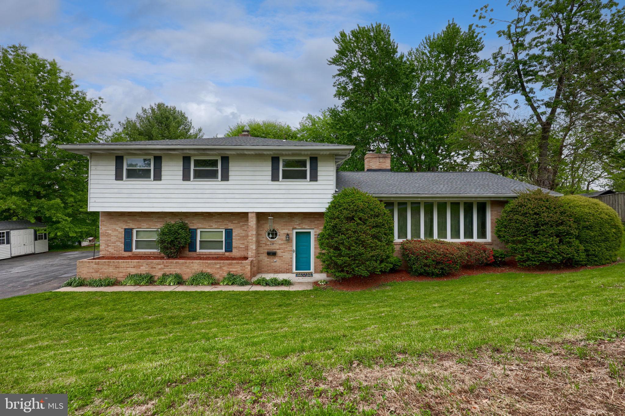 Welcome to this beautifully maintained split-level home nestled on a quiet street, yet just minutes from major highways and downtown Middletown. Offering the perfect balance of peaceful suburban living and urban convenience, this property sits on a generous .7-acre lot, providing plenty of space and privacy.

Step inside to a spacious entry that leads you into a warm and inviting family room, complete with striking tall wood-beamed ceilings, a brick fireplace with a wood stove insert, and large glass patio doors that bathe the space in natural light. This cozy yet open area is perfect for relaxing or entertaining year-round.

The kitchen boasts ample cabinet storage, a built-in range, and a wall oven, making meal prep a breeze. Adjacent to the kitchen, the formal dining room features charming built-in corner hutches and plush carpeting that flows seamlessly into the large formal living room – complete with a second wood-burning fireplace and tall windows that add elegance and brightness.

Rounding out the main level are a convenient laundry room, a powder bath, and a flexible space that can serve as a home office or a fifth bedroom.

Upstairs, you’ll find four spacious bedrooms and two full bathrooms, including a generous primary suite with its own private bath.

Step outside to your own backyard retreat! Enjoy the large, shaded yard and relax on the patio featuring a retractable awning – perfect for outdoor dining or simply unwinding after a long day.

Storage will never be an issue with abundant closet space throughout the home, a full basement, an attached garage, and an detached 8x12 shed – offering endless options for storage or hobbies.