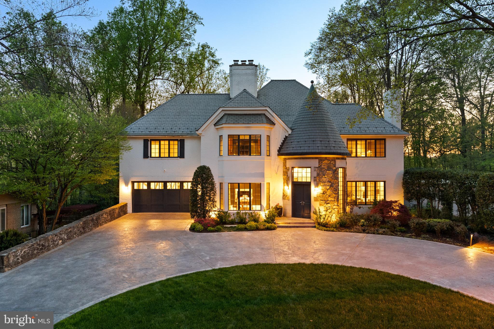 Welcome to a truly exceptional, fully reimagined estate set on a private half-acre in the heart of Bannockburn Estates. Spanning over 7,300 square feet across four impeccably designed levels, this rare offering is a seamless expression of architectural presence, elevated design, and resort-caliber living. A painted brick exterior, slate roof, and two striking turrets establish a sense of timeless distinction—an arrival that feels both grand and enduring.

With 5 bedrooms, 6.5 baths, and a dedicated office, the home is thoughtfully composed for both everyday living and sophisticated entertaining. Gracious proportions, curated materials, and a refined sense of flow create an environment that is as functional as it is beautiful, where each space unfolds with intention.

The kitchen is a study in precision and performance—anchored by a full suite of Miele appliances, including built-in espresso and steam systems—paired with custom Bulthaup cabinetry that delivers a clean, architectural aesthetic. Leathered stone surfaces introduce warmth and tactile depth, while a Wolf gas range with integrated griddle ensures professional-grade capability. Every detail has been considered, resulting in a space that feels both effortless and exacting.

The main level balances scale with intimacy. A formal dining room and elegant sitting room—each centered around a fireplace—set the tone for refined gatherings, while designer wall coverings and bespoke lighting lend richness throughout. A dedicated music room and private office provide moments of creativity and retreat. The home’s architectural character reveals itself in the circular turret foyer and the rear circular sitting room, where natural light enhances the home’s sculptural quality.

Upstairs, four en-suite bedrooms offer exceptional comfort and privacy, anchored by a remarkable primary suite that lives as a true sanctuary. Multiple Poliform closets provide tailored storage, while a private sitting room with fireplace and wet bar creates an intimate, residential retreat within the home. The 2023 primary bath, designed by acclaimed DC designer Joe Ireland, is both serene and striking—featuring a sculptural soaking tub set within the turret, fluted wood detailing, and a spa-inspired atmosphere that elevates the everyday.

Outdoors, the experience is equally compelling. Backing to mature trees, the grounds unfold into a private retreat designed for both relaxation and entertaining—featuring an infinity-edge pool with waterfall and hot tub, a stone-built Kalamazoo outdoor kitchen with integrated grill and Green Egg, and a full sport court. Retractable awnings extend the usability of the outdoor spaces, while irrigated garden beds add both beauty and purpose. A heated circular driveway and attached two-car garage with EV charging ensure ease in every season.

Inside, hydronic heated floors run throughout, complemented by a fully integrated smart home system controlling lighting, shades, and audio/visual as well as a whole house generator.

The walk-out lower level continues the home’s lifestyle offering with a spacious recreation room, dedicated gym, golf simulator-ready space, full bath, and two temperature-controlled wine cellars—bringing both leisure and function into perfect alignment.

Set among Bannockburn’s tree-lined streets and established estate homes, the location offers proximity to top-ranked schools, country clubs, parks, and major commuter routes—while preserving a sense of privacy and calm that feels worlds away.

A residence of this scale and caliber is rarely available—thoughtfully executed, architecturally distinctive, and truly exceptional.