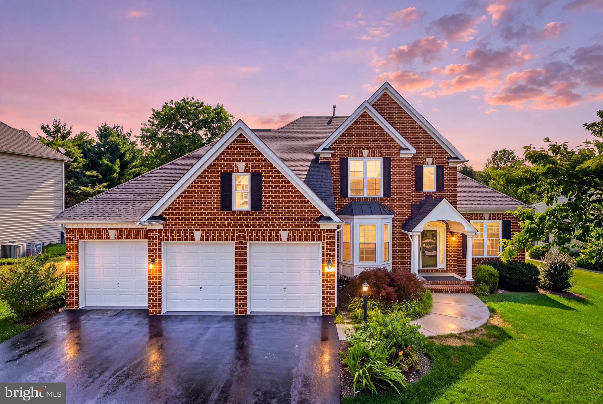 Experience timeless elegance in this exceptional Colonial residence nestled within the highly coveted Nottingham community of Mount Airy. Showcasing an impressive blend of classic architecture and sophisticated modern updates, this beautifully appointed home offers an expansive floor plan designed for both refined entertaining and everyday luxury.

A dramatic two-story foyer welcomes you inside, where stately columns, graceful arched openings, rich hardwood flooring, intricate moldings, and oversized windows create an atmosphere of understated elegance. The formal living and dining rooms provide sophisticated spaces for hosting, while the thoughtfully designed layout is anchored by the convenience of a desirable main-level primary suite.

At the heart of the home, the gourmet kitchen has been tastefully renovated with quartz countertops, a designer tile backsplash, abundant custom cabinetry, and a spacious center island with breakfast seating. The adjoining breakfast room is warmed by a stunning double-sided fireplace and opens effortlessly to the private patio and professionally landscaped, fully fenced backyard—creating a seamless indoor-outdoor living experience. A sun-drenched morning room, wrapped in windows overlooking the lush grounds, offers the perfect place to unwind, while the adjacent family room shares the ambiance of the double-sided fireplace, making it an inviting gathering space year-round.

The luxurious main-level primary suite serves as a private sanctuary, featuring a spa-inspired en-suite bath with dual vanities, a relaxing soaking tub, a glass-enclosed walk-in shower, and a spacious walk-in closet. A generously sized laundry room with direct access to the three-car garage and a beautifully appointed powder room complete the main level.

The upper level offers three spacious secondary bedrooms accompanied by two beautifully renovated full bathrooms, providing exceptional comfort and privacy for family and guests alike.

The finished lower level offers remarkable flexibility with a spacious recreation room enhanced by luxury vinyl plank flooring, a versatile bonus room ideal for a home office, fitness studio, or guest space, a full bath, and a substantial unfinished storage area.

Thoughtfully updated for today's lifestyle, this exceptional residence also features a three-car attached garage equipped with an EV charger, an inviting outdoor patio, manicured landscaping, and a private fenced backyard. Recent enhancements include quartz countertops, designer backsplash, refrigerator (2024), washer, dryer, and dishwasher (2023), along with a new kitchen sink (2025), ensuring a seamless blend of style, comfort, and modern convenience.

Offering distinguished craftsmanship, elegant living spaces, and an ideal location within one of Mount Airy's most desirable communities, this is a rare opportunity to own a home that truly exemplifies luxury living.