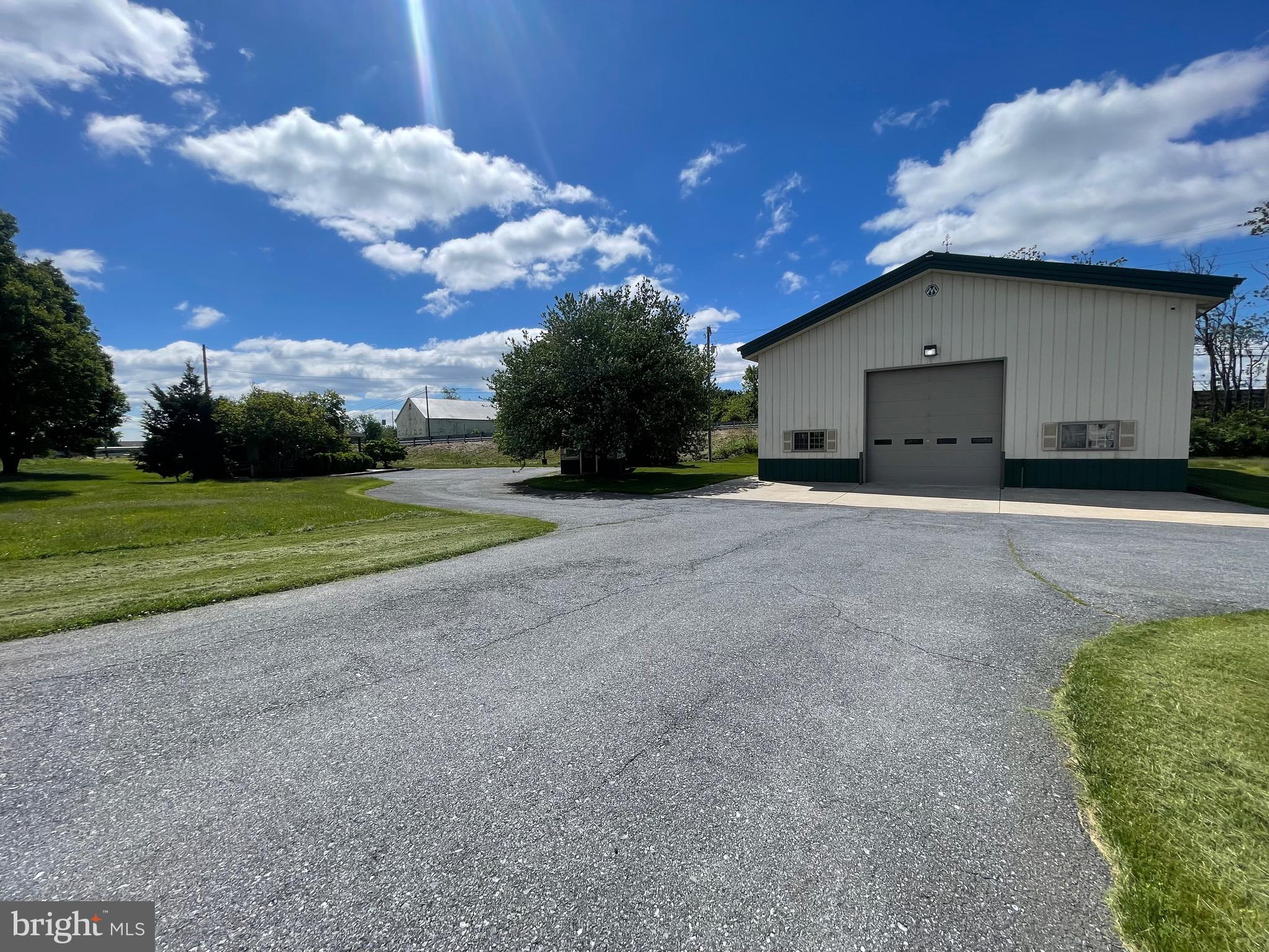 Rare opportunity to own a well-positioned commercial property directly off I-283 at Spooky Nook Road with exposure to over 40,000 ADT. Set on 1.79 acres, this versatile property is ideal for a contractor, service business, warehouse, office/storage use, or owner-user looking for a move-in-ready business location in a growing commercial corridor. The property features a 2,520+/- SF heated steel-frame building with 20’ ceilings, an oversized  garage door 14’ x 14’- grade-level.   Additional buildings include a detached 730+/- SF office building with ADA restroom, plus a third 300+/- SF building offering additional office and shed storage space with rear garage door. The property also offers a large, paved area ideal for parking, fleet vehicles, equipment staging, or outdoor storage. Current owners have added valuable improvements including a mini splits for heat/air, electrical, newer mechanicals, a full bath, storage room,  2 separate offices (10x11 and 10x15)  all within the main garage, and an additional room ideal for office, storage, conference, or flexible business use. Well maintained and highly functional, this property is easily set up for a new owner to move in and start operating quickly. Strong location, flexible layout, ample acreage, and excellent highway access make this a property you will not want to miss. Real estate only. Existing business and business assets are not included in the sale.