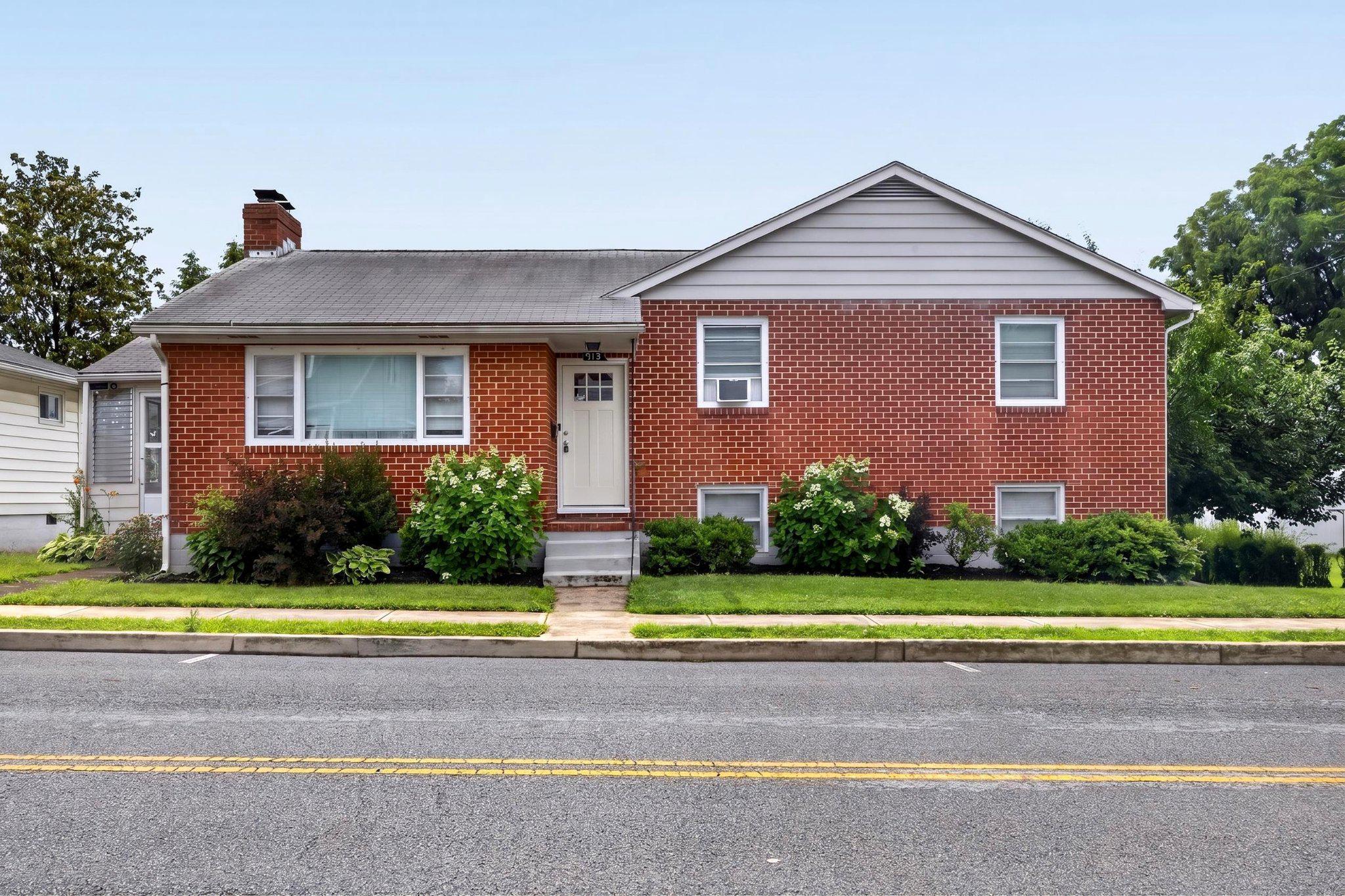Welcome home to this adorable, recently renovated three-bedroom, two full bath tri-level conveniently located in Hagerstown's South End. This open floor-plan home is a must see!  The main level features include a large kitchen with stainless steel appliances, a massive living room with plenty of space for a growing family, dining room area, and an intimate, screened-in enclosed porch just off the kitchen.  The upper level showcases the main full bath, generous master bedroom with dual closets, and 2 additional bedrooms. The lower level boasts a huge family room with gas fireplace, a custom entertainment center, large bar area with sink, a beer fridge and a second wine fridge.  This level also features an additional room currently used as an office, that would be perfect for an additional bedroom if needed.  A full bathroom, laundry area, and access to the oversized garage are also conveniently located on this level.  And you'll just love the added bonus of the cute reading nook tucked under the staircase!
Outside, the property is equally impressive. The beautifully landscaped yard features a patio and enclosed porch, ideal for outdoor dining or morning coffee. The fire-pit/entertainment area and playground equipment provide a perfect spot for leisure and recreation, while the outbuildings offer additional storage or workshop spaces. With a paved driveway, attached garage, and carport, parking is a breeze. This home is not just a residence; it's a lifestyle. Experience the perfect blend of comfort, elegance, and functionality in a location that offers both tranquility and convenience. Embrace the opportunity to make this stunning property your own and experience this private escape. Purchasing this home may qualify for the City of Hagerstown Homeownership Initiative grant program.  Professional photos coming soon!  Call Listing Agent with any questions. This one won't last, don't miss out.