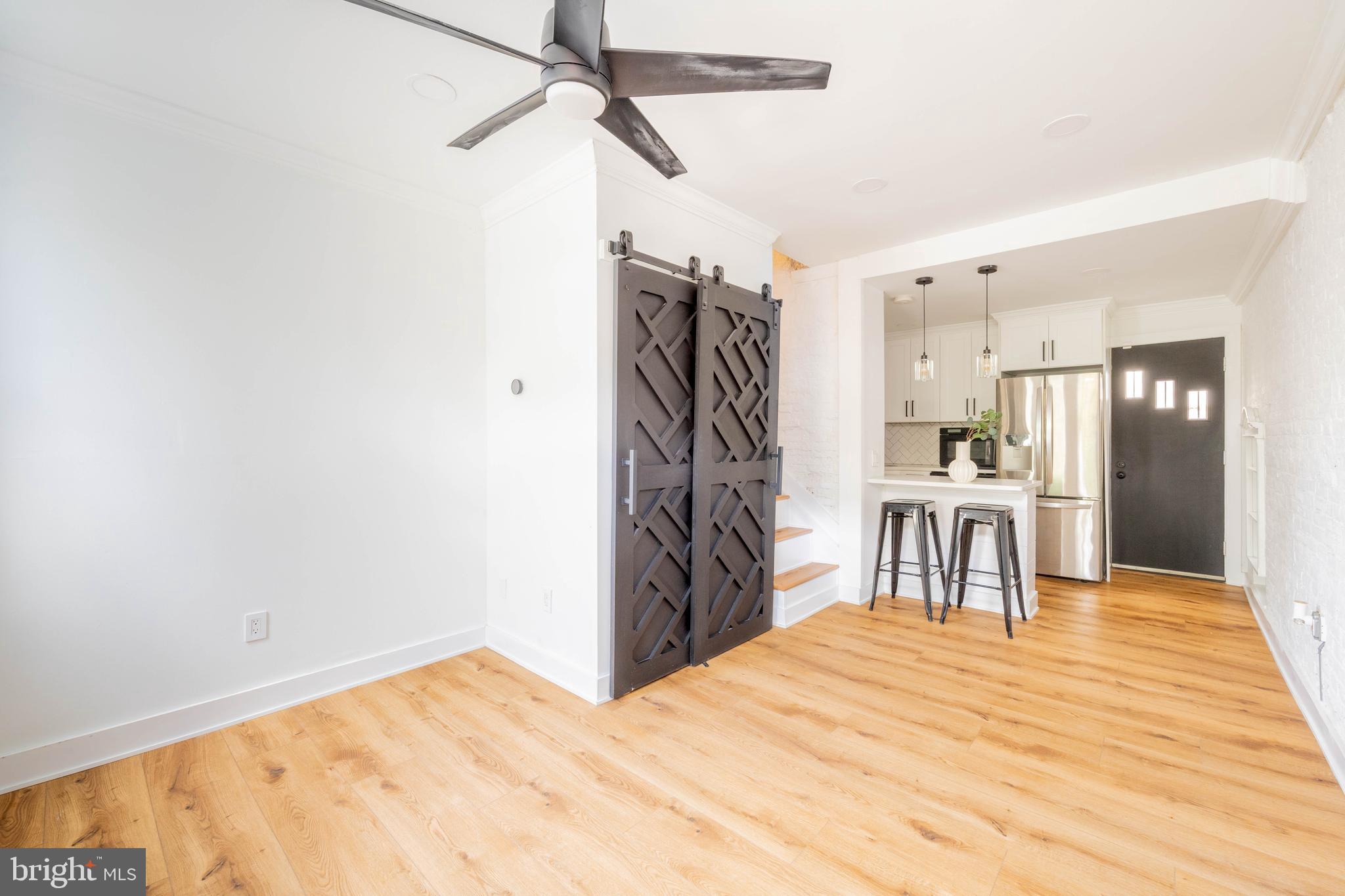 Stunning three story trinity with a roof deck, nestled on a beautifully maintained, tree lined street in the highly sought-after Pennsport neighborhood of South Philly. Step into a warm and inviting living room featuring hardwood floors, exposed brick, and an abundance of natural light. The open layout flows into a sleek kitchen with high-end stainless steel appliances — including a dishwasher and garbage disposal — custom cabinetry, and quartz countertops.

Upstairs, the second-floor bedroom boasts an oversized walk in closet with custom built-ins, a washer and dryer—because second floor laundry really is a game changer! The stylish bathroom includes a spacious rainfall shower with herringbone tile, a custom glass door, and high-end matte black finishes.

On the third floor, you’ll find another large bedroom with a beautiful custom accent wall that leads out to your private roof deck— complete with an outdoor shower. Just one block from scenic Jefferson Square Park, two blocks from Washington Ave, and close to local favorites like Charlie’s Roast Pork, Herman’s Café, Cake & Joe, and Pennsport Beer Boutique. Super convenient access to I-95, I-76, Columbus Blvd, and Center City! Pets allowed on case by case basis. Available May 1st!