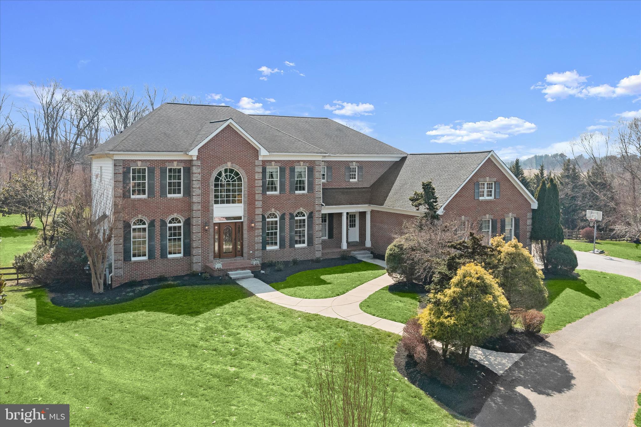 Magnificent custom estate nestled in the sought-after western Howard County, offering a serene and private countryside retreat with a resort-style backyard. Set on 3.17 picturesque acres, this exceptional residence boasts over 8,179 square feet of thoughtfully designed living space, blending elegance, comfort, and functionality. From the moment you enter, the grand foyer makes a striking impression with gleaming marble floors and an airy, welcoming presence. The formal living room showcases refined crown molding, a tray ceiling, and a gas fireplace, creating an inviting space for relaxation or entertaining. Opposite, the formal dining room is beautifully appointed with crown molding, chair rail detailing, and palladium windows, making it ideal for hosting memorable gatherings. At the heart of the home, the impressive family room features rich hardwood flooring, architectural columns, a coffered ceiling, a wood-burning stove (with a high-powered blower) framed by stone, a wet bar with a wine refrigerator, and direct access to the deck, enhancing both everyday living and entertaining. The chef’s kitchen is equally remarkable, offering granite countertops, a tile backsplash, 42-inch cabinetry, a center island, and premium Viking appliances, including a gas cooktop with range hood, double wall ovens, and a French-door refrigerator. Adjacent spaces include a bright breakfast area, a secondary family room, and seamless access to outdoor living. The main level also includes a private home office with Verizon FIOS for high-speed internet, a powder room, a laundry room, and a functional arrival center. Upstairs, accessible via dual staircases, the expansive primary suite serves as a luxurious retreat with hardwood floors, a ceiling fan, a sitting area, a spacious walk-in closet, and access to a finished bonus room with a private staircase to the garage. The spa-inspired primary bath features dual vanities, a jetted soaking tub, and an oversized shower with dual shower heads. Three additional generously sized bedrooms, each with en suite baths, walk-in closets, and ceiling fans, complete the upper level. The fully finished lower level offers exceptional versatility with a fifth bedroom, a recreation room featuring a wood-burning fireplace, enhanced with glass doors. A custom wet bar with a dishwasher, a beverage fridge, lots of cabinets, and dual-level countertops. A game room, an exercise room, a dual-entry bath, and walkout access. Outdoor living is equally impressive, with a deck enhanced by a pergola, a patio, and a gazebo, all overlooking a private saltwater pool with a deep end, diving board, a heavy-duty waterslide, and a cool water feature. Notable mentions include a greenhouse, a fenced garden, and a fully fenced tree-lined yard for privacy. Centrally located close to Columbia, Rockville, Silver Spring, Frederick, Fort Meade, Baltimore, and even Annapolis. Exceptional value in Western Howard County. Close to quality local public schools. This extraordinary property delivers the perfect blend of luxury, privacy, and lifestyle. Truly a place to call home.