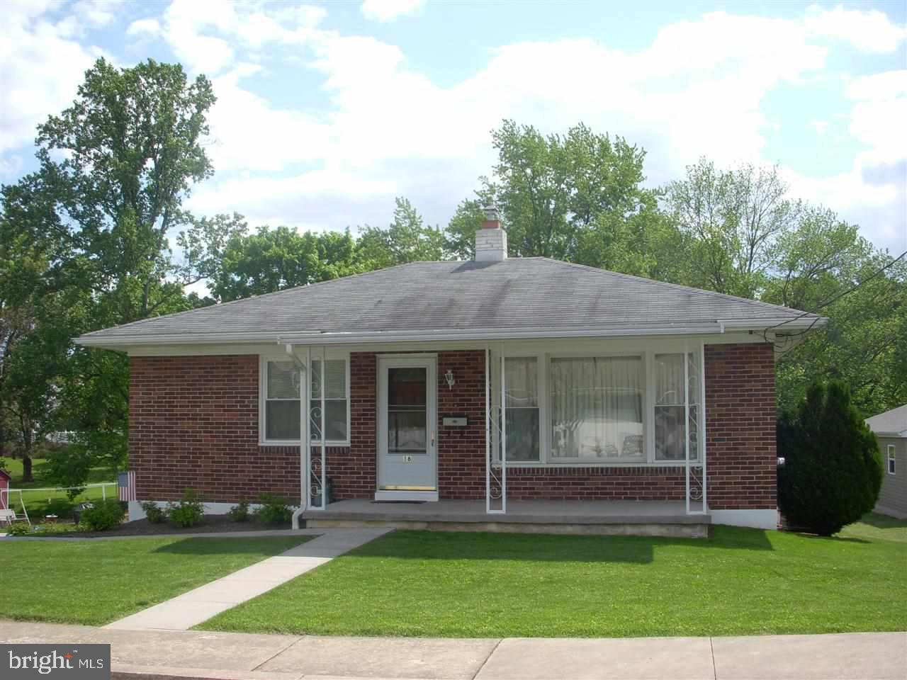 Charming 2 bedroom all brick ranch home with updated kitchen, hardwood floors, 1 car garage, gas heat and A/C, replacement windows, ample parking for up to 6 cars, level and private backyard.