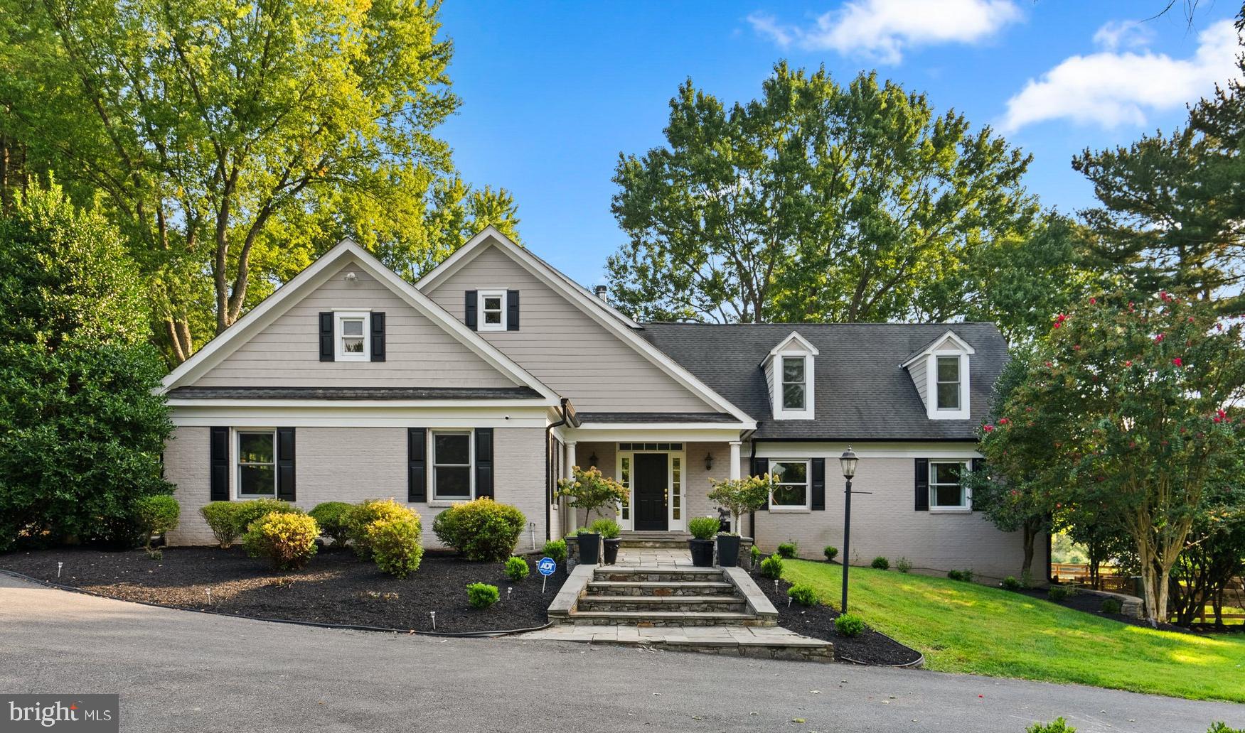 5 miles from the Potomac Village, 12810 Glen Road is a unique estate blending tranquility and modern comfort. Located within the highly acclaimed Wootton High School cluster, this home underwent a complete rebuild in 2006 and received a refreshing update in 2024.

Spanning 8,327 square feet, this residence contains oversized rooms, gleaming hardwood floors, modern yet classic updated lighting and flexible use spaces.  The interior has a crisp and clean aesthetic; entirely painted in a fresh white hue during the fall of 2023. 

The 8-foot wide entry hall flows past the wainscot adorned formal dining room and french doors that open into a private office to the great room. Arguably one of the most beautiful rooms, the enormous great room has picturesque views of the back 5 1⁄2 -acres, a stone surround gas burning fireplace (converted in 2024), and access to a deck leading to the side yard. 

The gourmet kitchen contains top-of-the-line stainless steel appliances, including a 6-burner gas cooktop with pot-filler and double ovens. The oversized island has a prep sink, wine refrigerator and seating for four. The kitchen seamlessly blends into a breakfast room with an exit to a  screened-in porch and flagstone patio. 

The main level also features a spacious bedroom suite with a walk-in closet finished with built-ins and bathroom with double vanity sink and bathtub. The ensuite bathroom has customizable lighting options for hanging pendants or over mirror vanity lights. The additional bedroom has double closets and access to the attached full bath (also accessible from the hallway).  A convenient mudroom/laundry area and half bath are located between the kitchen and garage. The mudroom has built-in cabinets and a utility sink as well as a side door to the driveway. The large, two car garage has built-in storage. 

The second floor features a sprawling primary suite with a gas fireplace, wet bar with sink and beverage refrigerator. The primary bath has a 4x8 shower with three shower heads and bench seat, a Bain Ultra air tub with jets and lights, and Emperador marble counters. The primary closet is not an ordinary closet but a room in and of itself with two separate walk-in areas and additional space that has the potential for customized built-ins. 

The landing on the second floor is generously proportioned, providing space for a sitting room or library area, with an adjacent hallway that can be utilized as a study area or activity space. Two additional bedrooms and a hall bath complete the second level.

The lower level has plenty of space for entertainment and relaxation, with 9-foot ceilings and a copper-topped bar with a sink, beverage refrigerator, full-size dishwasher, and built-ins for glassware, beverages and decor. This level also includes a recreation space, full bath and a bonus room with a closet. A separate area that can be used as an apartment or catering area provides additional functionality with a full-size refrigerator, double ovens, a 2-burner cooktop, a second washer/dryer, a wine storage room, and two utility/storage rooms.

Outside, the front of the home has an extended driveway and manicured lawn.. The immediate exterior features a flagstone walkway, back patio and side deck. The highlight of the outdoor space is the private 5-acre backlot, featuring a professionally maintained pond that can be stocked for fishing, a path encircling the pond, an 80 x 200 ft flat area primed for any type of sports court or pool adjacent to an 52 x 20 ft structure with insulated roof, running water and updated electricity, ready to be transformed into a pool house or sports clubhouse. The back 5 acres is enclosed by exterior fencing and the immediate backyard has brand new fencing. The 7.6 acres are made from two lots (12810 and 12812) being sold together. Currently, the property is a working horse farm and can be easily utilized as such. 

Please review noteworthy improvements and home facts available in the document section.