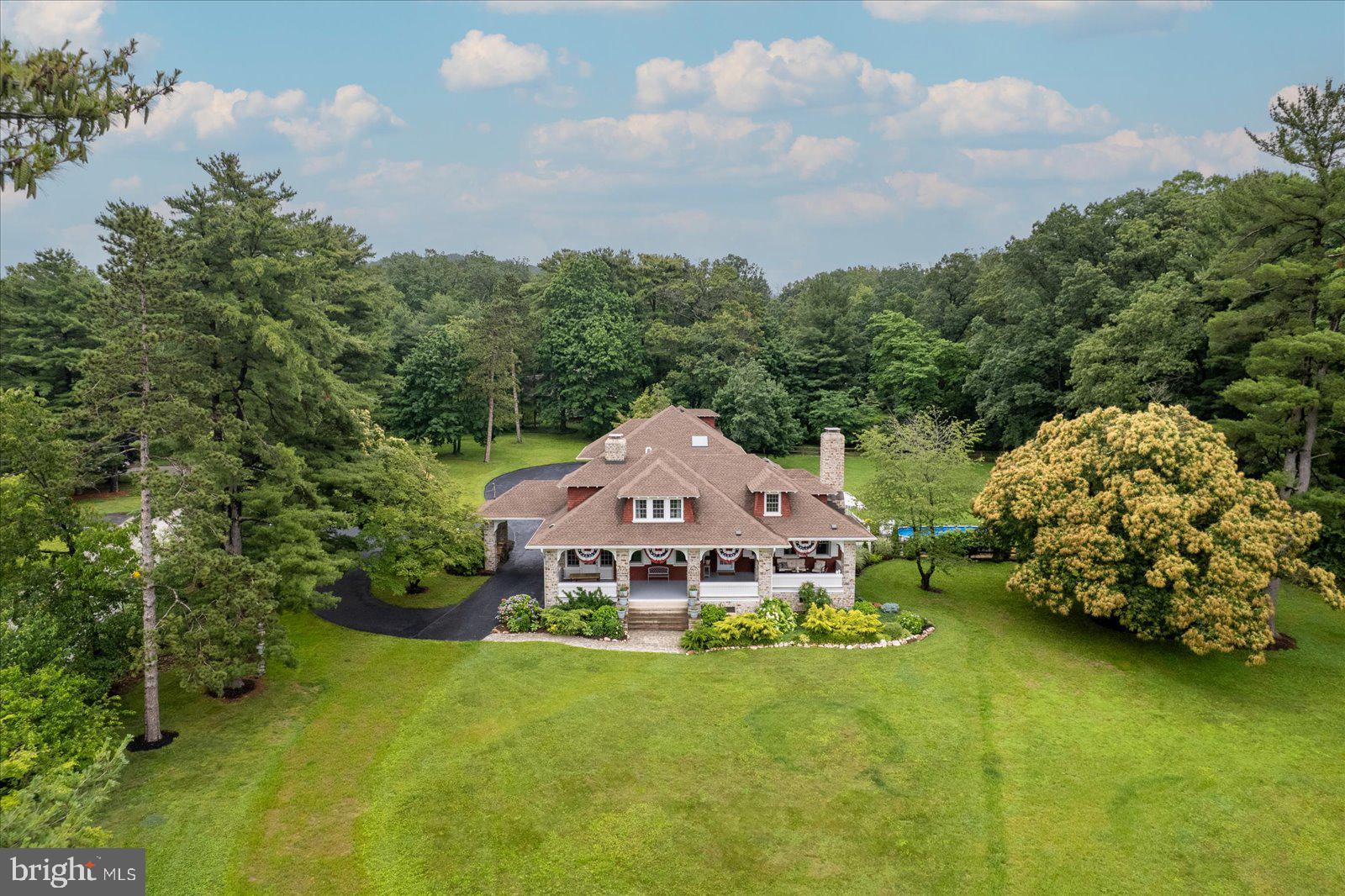 Described by many as the most beautiful home in Hanover, this 3-acre property sits high on a hill as a long-standing, recognizable Hanover estate.  There has been a meticulous construction overhaul to the property, preserving the history and incorporating luxurious upgrades and finishes.  The sweeping views of Hanover and beyond are one-of-a kind and stunning!  Opulence in the professional design abounds throughout the 5,241 sq ft residence boasting 6 bedrooms and 3.5 baths. Enter through the front door into an enormous living room and take in the extraordinary detail to the intricate moldings and craftsmanship. From the ceiling to the inlay flooring, it will be evident why this is an enduringly, admired Hanover property.  Pass by a 2nd living room, with endless possibilities for a reconfiguration to the buyers liking with a double-sided fireplace, leaded glass French door storage and butler pantry access.  Then enter the grand kitchen, masterfully upgraded in every way.  Walls have been removed, and this area was gutted to the studs, with support beams added, for a total dream space to cook and entertain.  SS appliances, 6 burner gas stove, restaurant quality hood, double oven, farmhouse sink, oversized island with seating, quartz counters, second convertible refrigerator/freezer, two wine coolers, coffee bar, natural lighting including skylight, 9” baseboard and imported flooring from Italy.  Featuring two stairwells, for rear or front of house access, the character of this home is thoughtfully woven into the new upgraded design.  Take note of the stained-glass windows, and pocket sun porch windows, with the option to screens or open air.  Eleven first-floor windows were updated with new, custom made insulated and noise cancelation, matching the original design for optimizing scenic views. Large rooms allow for a dining room, a recreation room and multiple living rooms to fit any family’s needs or wishes.  A large primary bedroom is also on the first floor. Enjoy outdoor living with plenty of space for animals, gardens and your hearts desires.  The new, maintenance free wrap-around deck, built with mirroring awning, gives this space 3 season living capabilities.  It is thoughtfully completed to include two OnDemand propane grill lines.  Invite quiet moments for fresh air, contemplation, private dinners, birdwatching or having morning coffee with a family of deer in your yard.  Daydream or let your every worry float away as you relax on a raft in the 11,000 gallon above ground pool.  Don’t miss the kitchen garden full of veggies and herbs and flower cutting garden.  Upstairs there are 6 more rooms and 2 full bathrooms. The primary bathroom is an oasis for relaxing in a soaking tub or enjoy the spacious walk-in shower, also note the private WC.  Double sinks and more natural light give this bright space the perfect touch for getting ready for your day.  Over 125 trees have been planted throughout the property including 2 rows along the 194 corridor.  Other home features are a Carriage house with upstairs storage, 2 car garage, utility shed, basement workshop, central air conditioning throughout, tankless hot water heater, public sewer, new roof, 10,000 watt essentials generator and so much more.  See the room-by-room highlight sheets for all betterments, improvements and home features. Watch the video tour or call to schedule your private tour today.  Minutes from dining, culture, education, shopping and more.  You will be at the top of the world at 2165 Broadway!