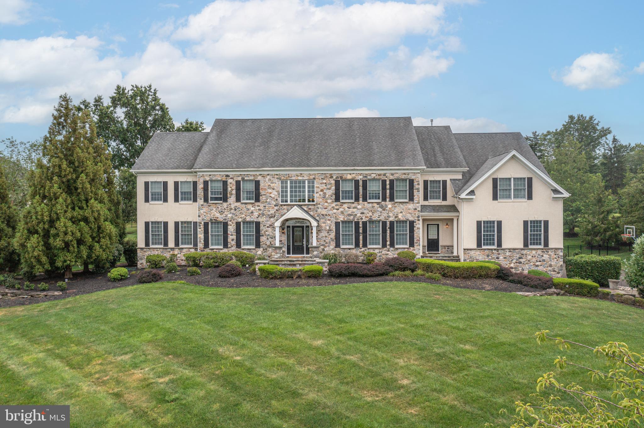 This custom residence in Matthew's Ridge offers an exceptional blend of luxury, comfort, and expansive floorplan. The home features a two story Foyer, formal Dining and Living rooms, Study with separate sitting room and built ins, large Conservatory, and a spectacular designer Kitchen with upgraded appliances, Atrium Breakfast Room with Palladian window and extensive workstation that features wine refrigeration and large center island. two story Family Room with floor to ceiling stone fireplace, 5 en-suite Bedrooms, including a luxurious primary suite with Sitting Room, 3 walks in closets, and a two sided fireplace. The walk-up lower level includes extensive exercise, games and entertaining space that includes wet bar. Other features include 10' ceiling height rich Brazilian cherry floors, elegant tray ceiling in Dining Room, Gas fireplaces, spacious four-car garage and state of the art mechanical systems.
Outdoors, the property is a true entertainer’s paradise. A custom cabana with its own bathroom, changing room, and surround sound system creates the perfect retreat beside the sparkling pool, complete with waterfalls and spa. Multiple refrigerators, a built-in bar, and a grilling station make hosting effortless, while the expansive deck and large grass lawn provides an ideal setting for gatherings and play space.  Professionally landscaped grounds with sweeping long-distance views—an extraordinary property in a truly desirable community location, award winning Council Rock School District  all within minutes from Newtown!