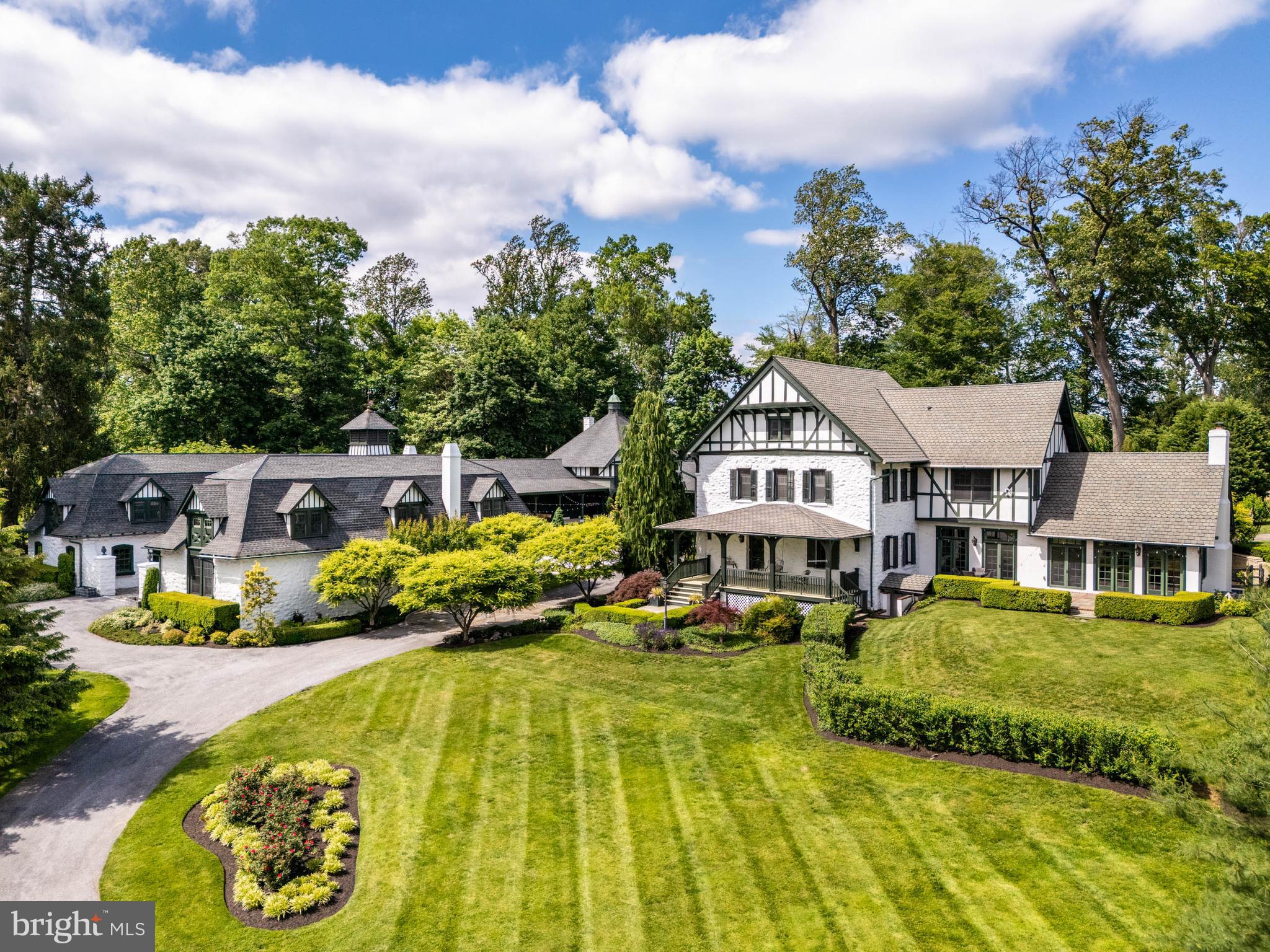 Historic Frank Furness-Designed Estate in Harrison Estates | Renovated and Expanded for Modern Living. 

Originally designed in the late 1800s by renowned Philadelphia architect Frank Furness, this one-of-a-kind property is what remains of the original Harrison Estate—now located in a walkable neighborhood of 40+ homes. While surrounded by newer construction, this stone property stands apart with architectural pedigree, expansive grounds, and a retreat-like lifestyle on 2.48 acres.

The estate includes a main residence, carriage house, and stables—together forming a private outdoor courtyard ideal for entertaining and relaxing. Extensive renovations between 2010 and 2025 blend the soul of the original architecture with updated systems, finishes, and amenities. The property offers remarkable versatility for gatherings, multigenerational living, and work-from-home flexibility. The newly installed front driveway and landscaping enhance its curb appeal.

The main house has four bedrooms with five and a half baths. Inside original hardwood floors are preserved with Australian cypress added in the expansion. Oversized windows and tall ceilings throughout fill the home with natural light and garden views. The family room features a gas fireplace and connects to the eat-in gourmet kitchen with professional-grade appliances. The main floor also boasts an elegant dining room, living room, study, foyer, powder room, and mudroom. The 2-room primary suite contains vaulted ceilings and dual walk-in closets. Also on the second floor are 2 ample bedrooms, each with en suite bath and closets. The third floor includes a full suite with great room, kitchen hookups, and bath—ideal for children, guests, or an au pair. The finished basement contains a gym with full bath and a room ideal for wine storage.

The separate carriage house, transformed between 2010–2013, includes a custom catering kitchen, full bath, three bedrooms, additional garage storage for many cars, and private entrances. A home theater with surround sound, Sonos system, wet bar, game areas, and stage with exceptional acoustics make it the ultimate series of spaces for hobbies, entertaining, and overnight guests.

The L-shaped stables now house a primary four-car garage (EV setup expected June 2025), historically inspired stamped concrete floors in the undercrofts, potting shed, and stairs leading upstairs to an architectural masterpiece awaiting reimagining. Materials from the original structure have been carefully repurposed throughout.

This estate is as livable as it is historic—a beautifully preserved Frank Furness home reimagined for contemporary life, offering space, comfort, and legacy in one of the Main Line’s most desirable settings.