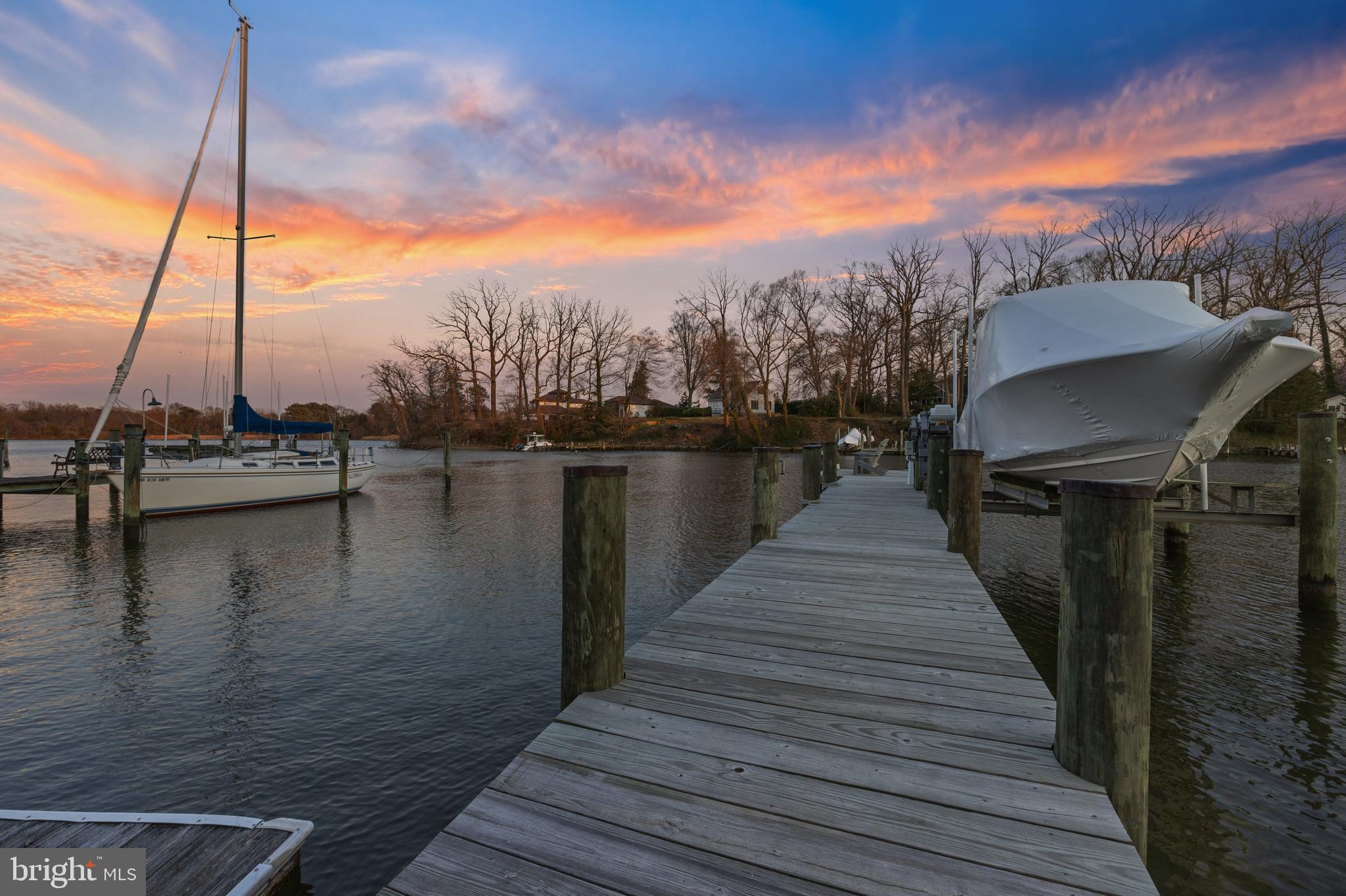 Experience waterfront living at its finest in this meticulously updated waterfront beauty. Perched above the serene shores of Minnow Creek just off Whitehall Creek, this coastal cottage-inspired home offers the perfect escape for year-round living, weekend getaways, or rental opportunities. Wake up every morning to the gentle stirrings of the water fowl as the sun casts a warm glow across Minnow Creek, feeling a sense of anticipation for the day ahead. Open the sliding doors onto the expansive waterside deck and inhale the salty breeze, letting it rejuvenate your spirit as you savor your morning coffee in the cozy sunroom with brick floor and vaulted ceiling. The soft light filtering through the windows enveloping the open floor plan of the Kitchen, Living and Dining room beautifully illuminates the 200-year-old heart pine flooring beneath your feet. The antique paneling surrounding the fireplace, the expertly crafted bookcases in the dining area and the attention to detail combine to showcase the timeless beauty of this home. Throughout the day, immerse yourself in the tranquil surroundings. Lounge under the waterfront pergola, take a well deserved nap in the main level Bedroom or curl up with a book in the guest bedroom window seat as you gaze out at the serene views.  Indulge in leisurely afternoons spent fishing off the private pier or basking in the sun's rays on the floating dock. The tranquility of no-wake waters will delight boating enthusiasts with endless opportunities for recreation and the location provides quick and easy access to Annapolis, the Chesapeake Bay and beyond. As the sun sets, painting the sky in hues of orange and pink, light the pergola and watch as the deck comes alive with warmth and charm. As night falls, retreat indoors to the luxurious Primary bedroom suite letting the sound of the water lull you to sleep, dreaming of another day in your waterfront paradise. This isn't just a home—it's a lifestyle. Embrace the simple joys of the waterfront lifestyle and make this retreat your own. Every day you'll be reminded of the beauty and serenity that await you in this idyllic haven. Welcome Home!