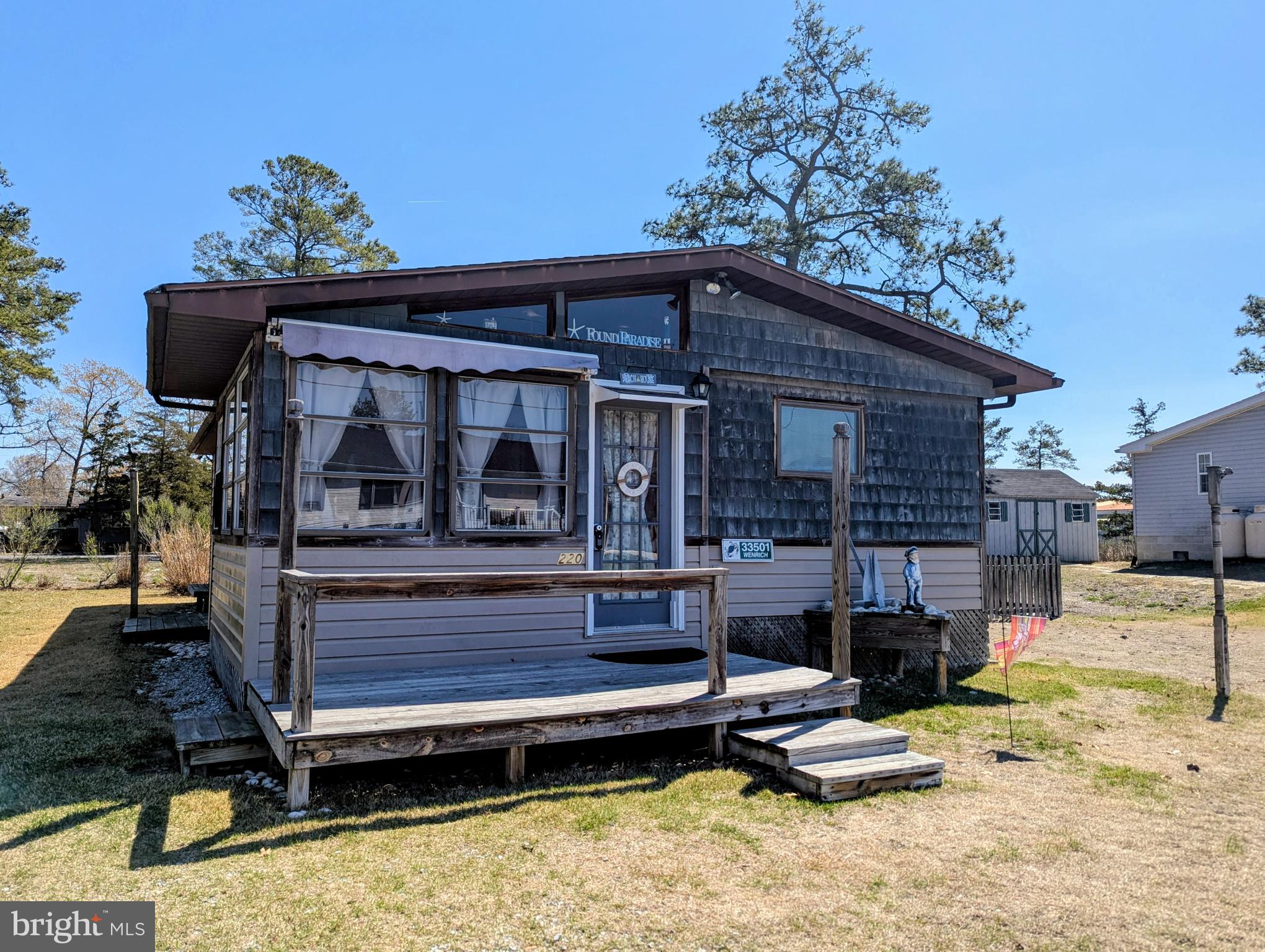 PRICE IMPROVEMENT!!!Great Beach House has room for your family and friends!  This modified single wide has over 1000 square feet of living space, a large Sunroom on the front, site built Living Room with Vaulted ceilings, one bedroom in the addition and three more bedrooms in the main home. The Central A/C was replaced in 2023, and the heat is electric.  Most of the furniture may convey with the home at buyer's option.  This home is situated on a nice size corner lot and offers a fenced in yard for your children and pets and a storage shed for all your beach needs, plus an outside shower with surround!  The home is spacious enough for several people to be comfortable and one bedroom has a private half bath.  The Sunroom, Living Room addition, front deck and one bedroom were built in 1989.  The lot rent is $787 per month which includes trash/recycle pick up.  Why not make this your year to enjoy the beach, salty air and sunshine!