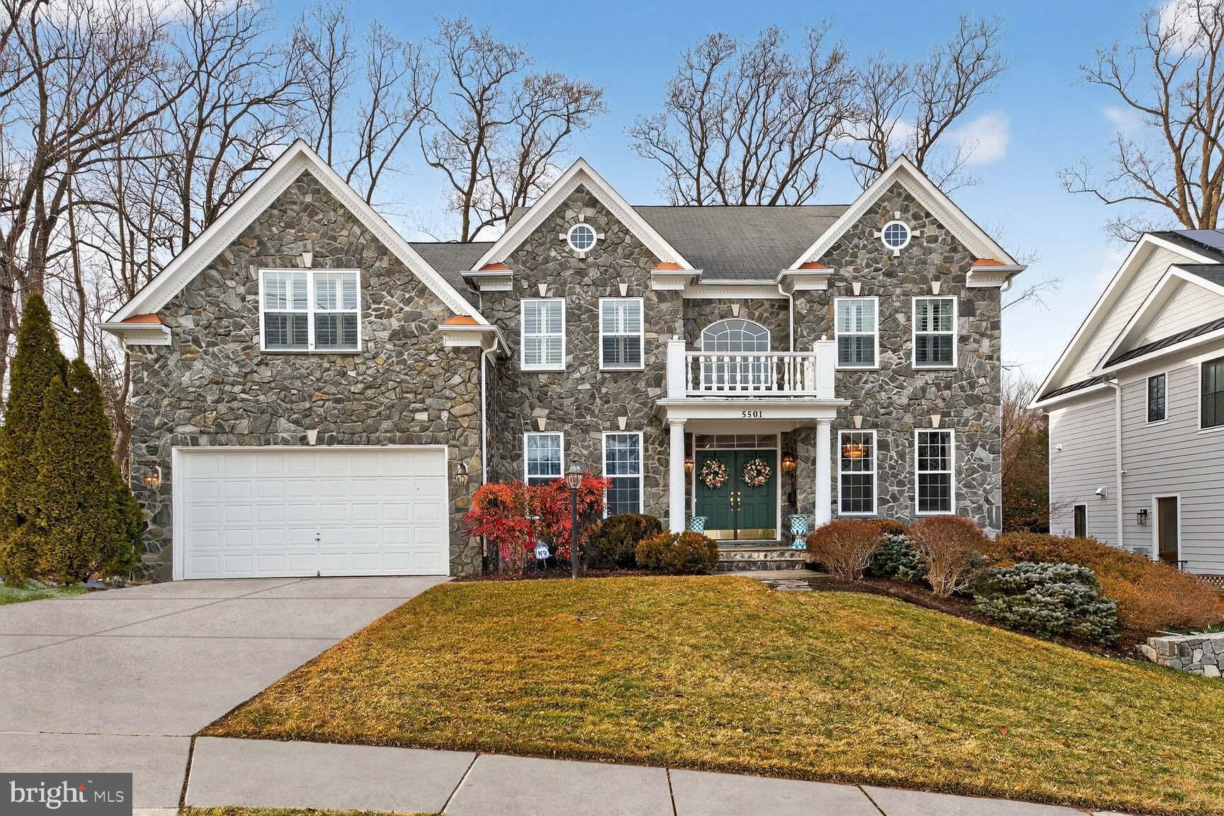 Welcome to 5501 36th Street N. in Arlington, a stunning 5 bedroom, 4.5 bathroom single family home in sought-after Williamsburg Village that can easily live as a 6 bedroom residence thanks to a versatile main level room perfect for a bedroom, office, or playroom. From the moment you arrive, the storybook stone façade, brick on all 3 other sides, covered portico with stately columns, charming second-story balcony, and grand double doors create unforgettable curb appeal. Inside, a dramatic two-story foyer with cultured marble tile and a sweeping staircase sets the tone, while fresh neutral paint, designer lighting, recessed lights, and gleaming hardwood floors throughout the main and upper levels showcase the quality craftsmanship poured into this home.

The open concept layout is anchored by a breathtaking two-story family room with soaring 25-foot ceilings! With a floor-to-ceiling wall of windows overlooking the private backyard, gorgeous trim work, and a contemporary gas fireplace flanked by built-ins, this room has SHOWSTOPPER written all over it! From casual nights in to megawatt holiday parties, this room screams SUNNY, WARM, and the HEART of the HOME! 

The adjacent chef’s kitchen features on-trend white and gray shaker cabinetry, granite countertops, a marble herringbone backsplash, a professional-grade Thermador appliance suite with wall oven and built-in microwave, and a large island with prep sink and a second oven with six-burner gas cooktop beneath a sleek industrial stainless hood. A sunny morning room with breakfast bar seating and French doors opens to the Trex deck and stone patio, creating seamless indoor-outdoor living. The elegant dining room offers sunny windows, chair rail, custom box trim molding, and a built-in wet bar with wine fridge, while the living room blends refined trim detail with dramatic wallpaper and a crystal chandelier.

Upstairs, two staircases lead to a gracious hallway overlooking both the foyer and family room. The primary suite is a true retreat with tray ceiling, sitting area, two massive walk-in closets, and a private wet bar with mini fridge and microwave. The spa-like bathroom includes a soaking tub, oversized glass-enclosed shower, dual granite vanities, makeup station, plantation shutters, and a separate water closet. Three additional upper level bedrooms are spacious and sun-filled, including one with a private en suite and two connected by a Jack-and-Jill bathroom with double sinks.

The walk-out lower level is designed for living and entertaining, featuring a large rec room with LVP flooring, a dedicated exercise room, art studio, abundant storage, and a spectacular home theater with tiered reclining seating, projector, screen, and surround sound that all convey. A fifth bedroom with sitting area and walk-in closet, paired with a full bath, makes an ideal guest suite, in-law space, or au pair retreat.

Outside, the rare 0.23-acre lot offers a large, flat, fenced backyard with mature trees, a flagstone patio, and an elevated Trex deck perfect for gatherings. Additional lovely features include a spacious two car garage, multi-zone HVAC, and a prime location in the Discovery, Williamsburg, and Yorktown school pyramid – walk 0.2 miles to Discovery Elementary School, 0.4 miles to Williamsburg Middle School, and 1.1 miles to Yorktown High School! Ideally located near parks, shopping, dining, and an easy commute to Tysons and Washington, DC, this exceptional residence offers the perfect blend of luxury, space, and location.
