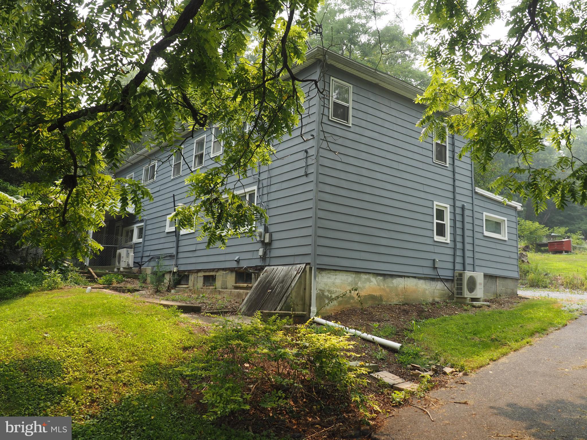 So many possibilities for under $200K! Major renovations were done in 2020, but there is still room to make it your own with finishing touches. This home is currently set up as a 2 unit or attached in-law suite. Bottom unit has one bedroom and an office. The upstairs has 2 bedrooms. And there is room to expand either unit. Updates include electrical, heat pump, mini split, & water heaters. Utilities are not separated. The home sits on almost an acre with an outbuilding for storage. Being sold As-Is.