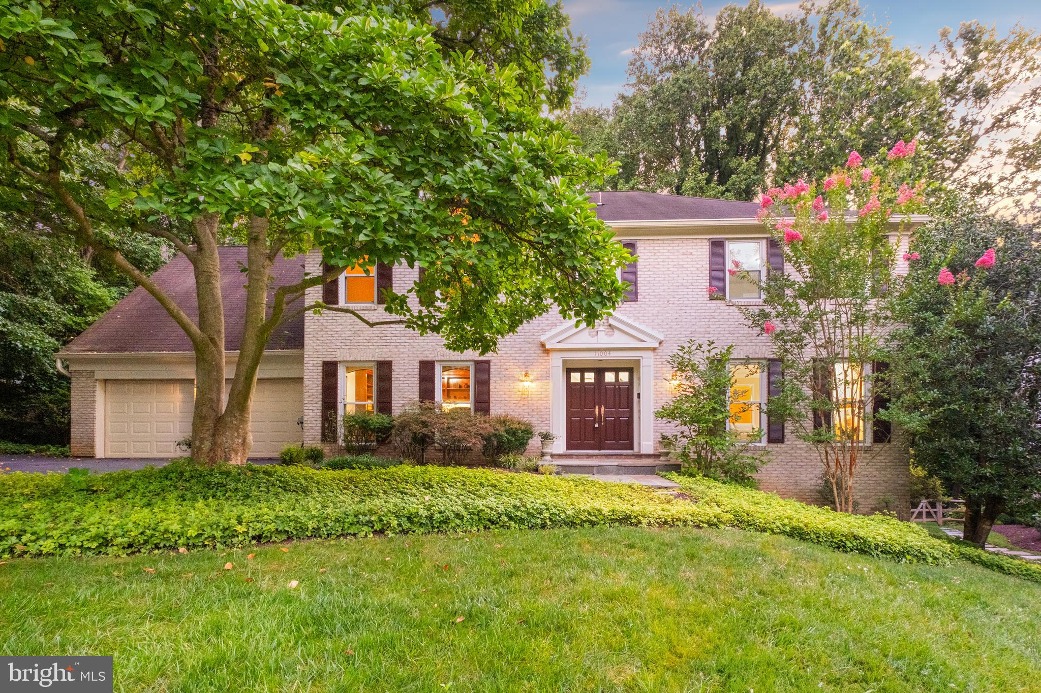 Welcome to 11004 Roundtable Court, a distinguished all-brick Colonial tucked away on a private and highly desirable cul-de-sac in the prestigious Windermere (Heritage Walk) community of North Bethesda. This stunning home features seven bedrooms, four and a half bathrooms, and a thoughtfully designed floor plan ideal for both everyday living and entertaining.
A dramatic two-story foyer crowned by a Murano glass chandelier sets the stage, leading to formal living and dining rooms that exude classic elegance. The living room showcases custom oak built-ins and a cozy gas fireplace, while the spacious dining room offers a view of the home's lushly landscaped backyard. A private office, adorned with rich cherry wood built-ins, provides an inspiring setting for work or study.
A chef's delight, the spacious eat-in kitchen features quartz countertops, stainless steel appliances, and ample cabinetry. A main-level laundry adds everyday convenience, while recessed lighting and a smart lighting system enhance the home's warmth and functionality.
Upstairs, you'll find five generously sized bedrooms and three full bathrooms, including a luxurious primary suite with his and her walk-in closets, a wood-burning fireplace with Italian marble, and a spa-inspired ensuite bath. The updated bathroom features Italian marble finishes, a steam shower, a jetted tub, double sinks, a bidet toilet, ample storage, and a built-in speaker and lighting system.
The fully finished lower level offers exceptional flexibility, complete with two additional bedrooms, a stylish updated full bath, a kitchenette, a spacious recreation area, and walkout access to the backyard. Perfect for guests, extended family, or a private retreat.
Outdoors, the 25,000 sq. ft. professionally landscaped oasis provides a secluded sanctuary. A large deck with a mister system, a retractable awning, and a wisteria-covered trellis overlooks colorful azaleas and a private basketball court. Additional features include an irrigation system and an oversized two-car garage with a brand-new epoxy floor.
Windermere residents enjoy exclusive access to premier amenities, including a pool, clubhouse, and tennis/pickleball courts. Ideally located minutes from Montgomery Mall, Pike & Rose, Cabin John Park, Strathmore, and major commuter routes, this home also sits within the top-rated Montgomery County school district.
This is a rare opportunity to own a beautifully maintained, thoughtfully expanded residence in one of North Bethesda's coveted neighborhoods.