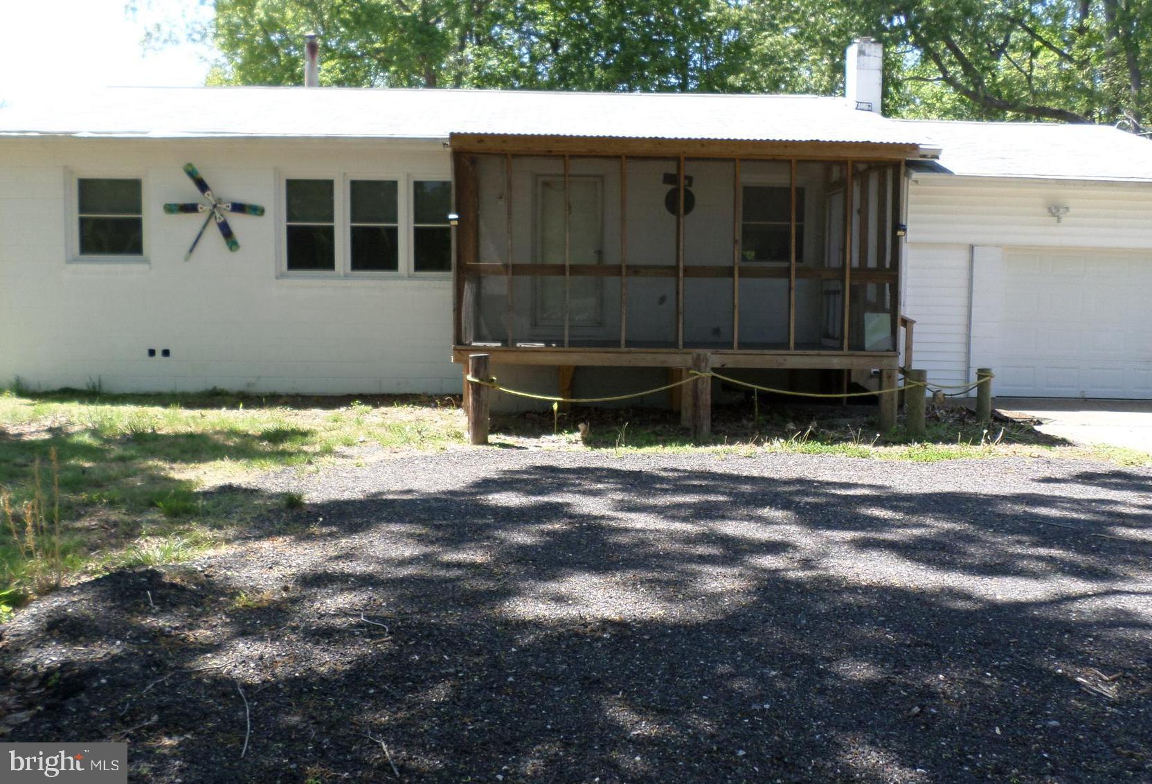 Enjoy a like-new home recently updated with new flooring, 2 updated bathrooms, and some painting. The roof and windows were replaced in 2019, and a new HVAC system was installed in 2017. The oversized kitchen offers a buffet bar with a sink and cabinets. You'll enjoy the comfort of lounging on the new 8 x 12 screened-in front porch. The home has an attached one-car garage, a separate detached 1-car garage with storage space, and a 6-car driveway, offering ample space for vehicles. Both garages have electricity and workshop space. The large yard provides plenty of space for outdoor living, gardening, and entertaining. Also includes a 23" camera TV and 3 televisions (one 55" big screen). Schedule a tour today!