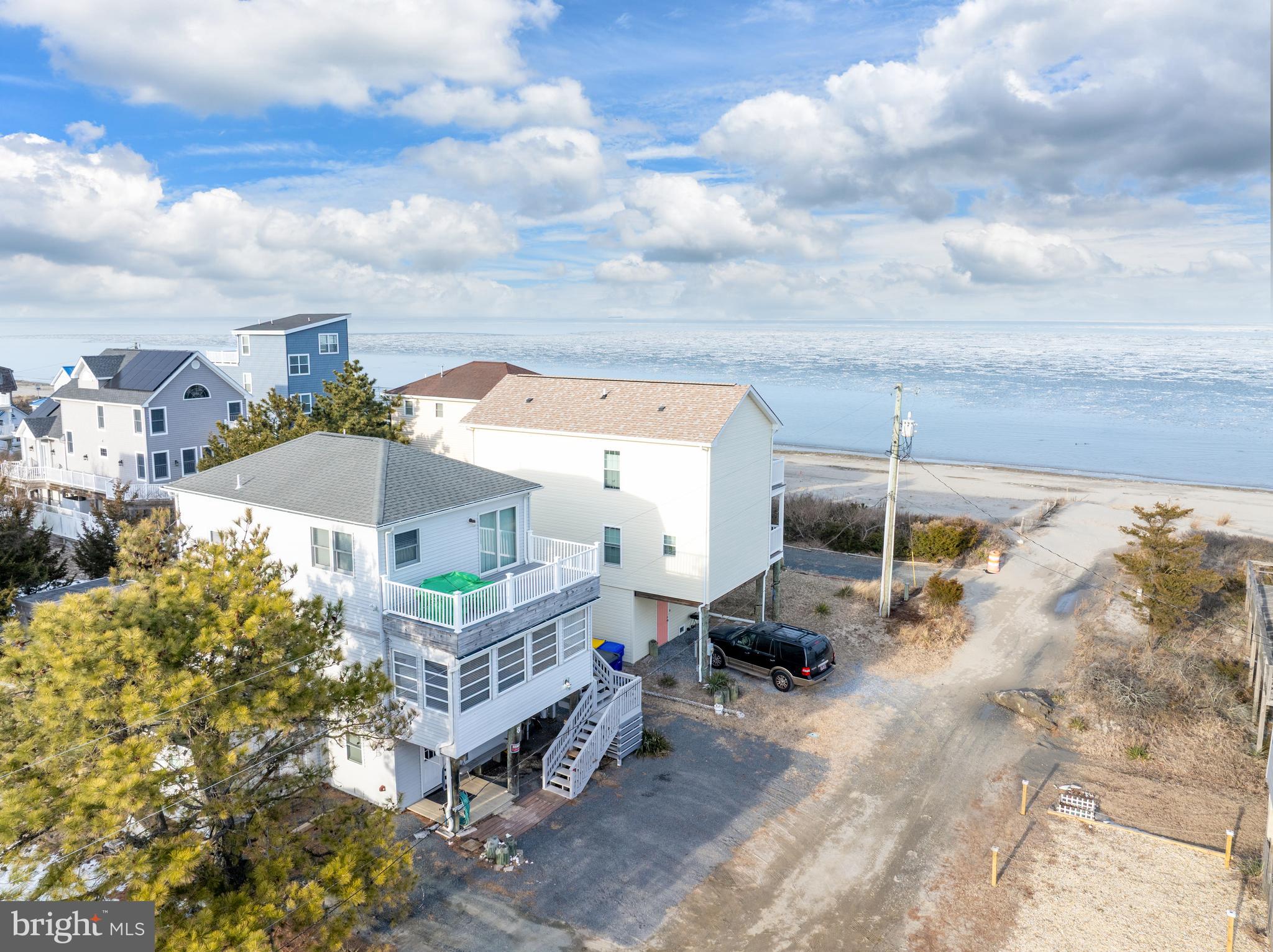 Live Where You Vacation — With Incredible Income Potential!
Rare opportunity to offset your ownership costs or create a powerful investment opportunity by renting the downstairs space while enjoying the upstairs for yourself — generating an estimated $30,000+ annually in rental income for just the downstairs 1 bedroom space. Want even greater earning potential? Rent both levels for maximum income possibilities in this highly desirable coastal location. Nestled in the charming community of Broadkill Beach, this delightful coastal home offers a perfect blend of comfort and style, ideal for those seeking a serene retreat. Built in 1950 and thoughtfully renovated in 2021, this residence boasts a timeless appeal with modern conveniences. Step inside to discover a warm and inviting interior featuring three spacious bedrooms and three and a half bathrooms. The heart of the home is a beautifully designed country kitchen, complete with an island, pantry, and a cozy kitchenette, perfect for casual meals or entertaining. The open layout seamlessly connects the kitchen to the family room, where exposed beams add character and warmth. Natural light pours in through the window treatments, creating a bright and airy atmosphere throughout. The primary suite is a true sanctuary, featuring a luxurious soaking tub and a walk-in shower, providing a spa-like experience right at home. Additional interior highlights include plush carpeting, durable vinyl, and elegant hardwood flooring, ensuring both comfort and style in every room. Outside, the property continues to impress with its inviting exterior features. Enjoy the fresh coastal air on the enclosed porch or unwind on the spacious deck, perfect for summer gatherings or quiet evenings under the stars. An outside shower adds convenience after a day at the beach, while a shed provides extra storage for all your outdoor gear. With a lot size of 0.11 acres, this home offers a manageable outdoor space that is easy to maintain, allowing you to spend more time enjoying the nearby Delaware Bay. The stunning bay views create a picturesque backdrop, enhancing the overall tranquility of the property. Parking is a breeze with off-street and driveway options, ensuring you and your guests always have a place to park. This home is not just a residence; it’s a lifestyle, offering the perfect blend of comfort, convenience, and coastal charm. Whether you’re looking for a year-round home or a seasonal getaway, this property is ready to welcome you with open arms. Embrace the coastal living experience and make this charming Broadkill Beach home your own!