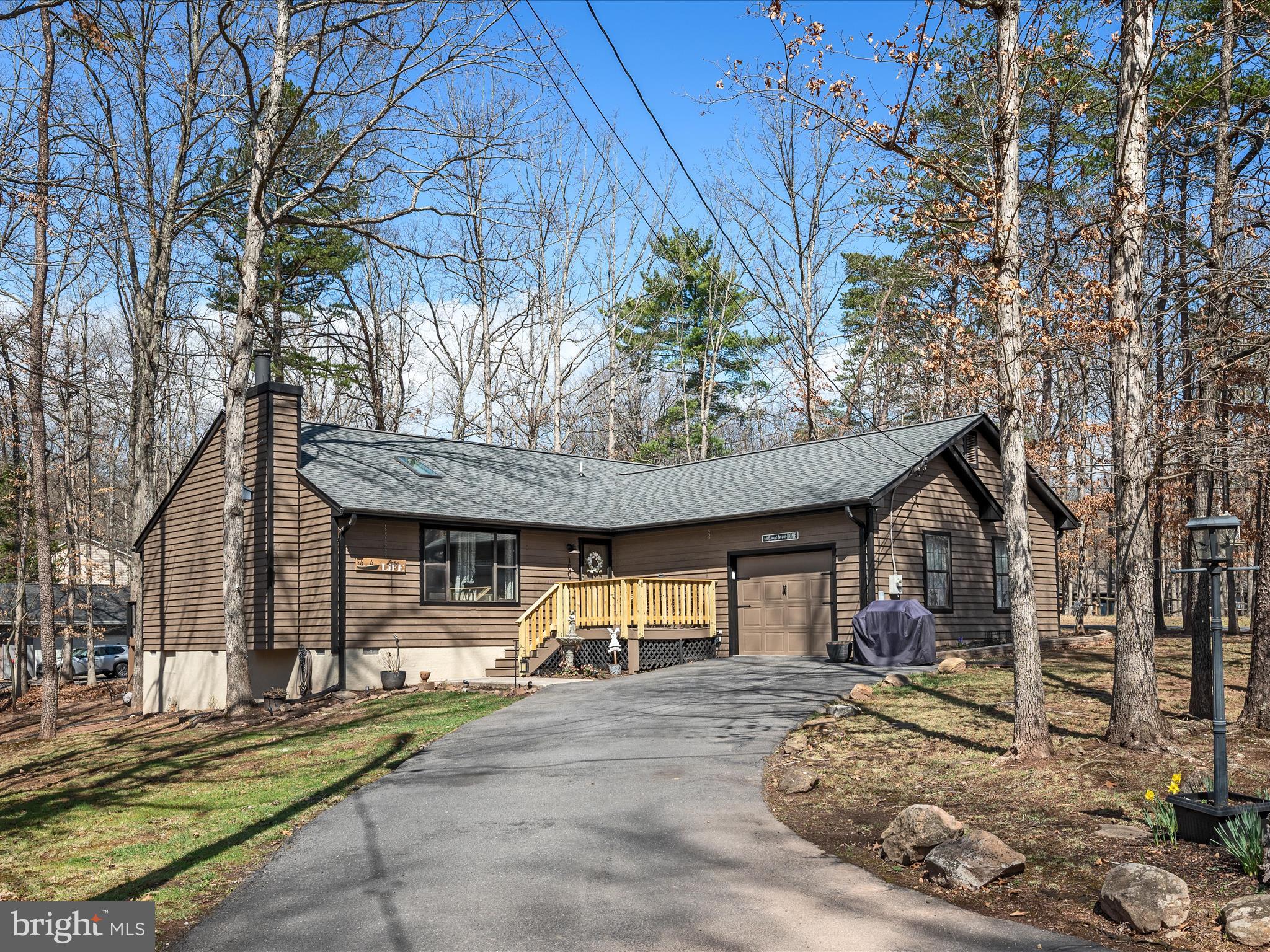 Beautifully Updated Rancher in Gated Lake Community!
This spacious one-level home offers nearly 1,800 square feet of comfortable living, featuring large rooms, vaulted ceilings with a skylight, and a cozy wood-burning fireplace in the living room. Freshly painted in a neutral palette with new flooring, it’s move-in ready! The exterior has just been stained, and the new front porch adds a delightful touch of curb appeal. The updated kitchen boasts a breakfast bar, an attached dining area, and new stainless steel appliances. The expansive primary suite includes a luxurious attached bath. Nestled on a level, wooded corner lot in a quieter section of this 240-acre lake community, this home offers both privacy and charm. Come bring your boat and enjoy the many amenities that Lake Holiday offers: 3 sandy beaches, clubhouse with fitness room and picnic areas, fishing pier, marina, tennis/volleyball/pickleball/basketball courts, walking and hiking trails, dog parks and a 24/7 security gate. Don’t miss the opportunity to make this beautiful home in a vibrant lake community your own!