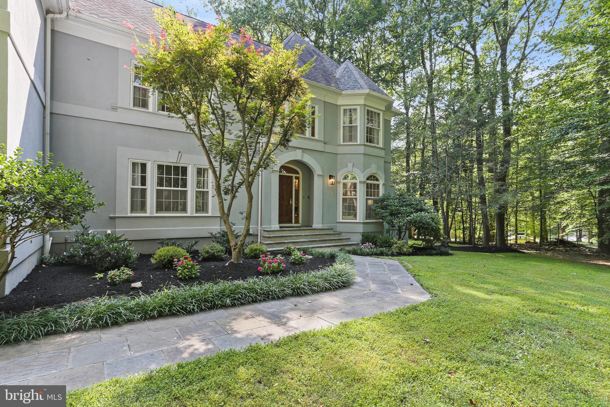 Extraordinary custom-built home nestled on a breathtaking 3+ acre lot of the highly sought after Chapel Woods, offering an unparalleled living experience, combining privacy, serenity, and endless possibilities for relaxation and entertainment. 
Key features: 6 bedrooms, 4.5 bathrooms, and 3 car side entry garage. Awesome Outdoor Oasis - Enjoy a heated swimming/diving pool, extensive hardscape, fire pit, gazebo, deck, kids play area, and a huge usable front and backyard perfect for sports, gardening, family and friends gatherings.   
Exquisite Architecture: The striking architectural details include hip roofs, multiple bay windows and 3 sets of rear patio doors that frame stunning views from every angle. A bluestone walk path accented with flowering beds leads to a charming stone stoop and arched front porch. 
Grand Entryway: Step inside to a two-story foyer with side stairs and flanked by three sets of French doors, providing privacy for the main level library, living room, and formal dining room. 
Gourmet Kitchen and breakfast area: The renovated main kitchen is a chef's delight, featuring built-ins, floor-to-ceiling cabinets for ample storage, a center island, and new floor-to-ceiling patio doors and expansive bay windows showcasing panoramic views while you prepare or enjoy meals. 
Seamless Indoor-Outdoor Living: The family room, located off the kitchen and the breakfast area, features floor-to-ceiling windows and two sets of patio doors that open onto a large deck. A separate laundry room offers one more French door to the deck. 
Luxurious Primary Suite: A setback stairway leads to the gorgeous primary suite with tray ceilings and multiple windows for picturesque views of the trees and crystal-clear blue water in the pool, three additional bedrooms on the upper level, each with walk-in closets and beautiful views. 
Versatile In-Law Suite: A separate staircase leads to a private in-law suite, including a fifth bedroom, a sizable walk-in closet, a third full bathroom, an updated kitchen with new quartz countertops, energy-efficient appliances, LED ceiling lights, and an oversized media room with multiple windows.
Entertainment Haven: The top level offers a massive attic rec. room with 3 skylights – a hidden hideaway, a cozy clubhouse, and a whimsical retreat that kids love. A separate door leads to an informal movie theater – great for learning and entertaining. 
Finished Lower Level: The beautifully finished basement presents a 6th bedroom, a 4th full bathroom, a multi-functional recreation room with a wet bar, a game room, a spacious home gym/dance studio, and a large storage room. 
Modern Conveniences: Multiple media rooms provide tailored entertainment zones, allowing family members to engage in different activities simultaneously—such as movies, or sports—without disruption. These versatile, multi-purpose spaces enhance daily living, and support modern, flexible lifestyle.
A Bose surround sound system in a few rooms offers various facilities for luxurious living. 
EV charger in the 3 car side entry garage. 
Super convenient location: within one mile to River Hill schools, while a convenient bus stop at the end of the driveway serving all grades. 
The Chapel Woods community enjoys the easiest commuting "Against the Grain" Traffic: driving in the opposite direction of the "rush" (the crowd), to the River Hill Elementary and High Schools. Minutes to River Hill Village Center, Clarksville Commons, fine restaurants, grocery stores, farmer’s markets, professional and medical services. The Linden Chapel Road within the community leads directly to Mary’s Land Farm.  
Easy access to 32//29/95, Columbia, Rockville, D.C., Baltimore, and Annapolis.