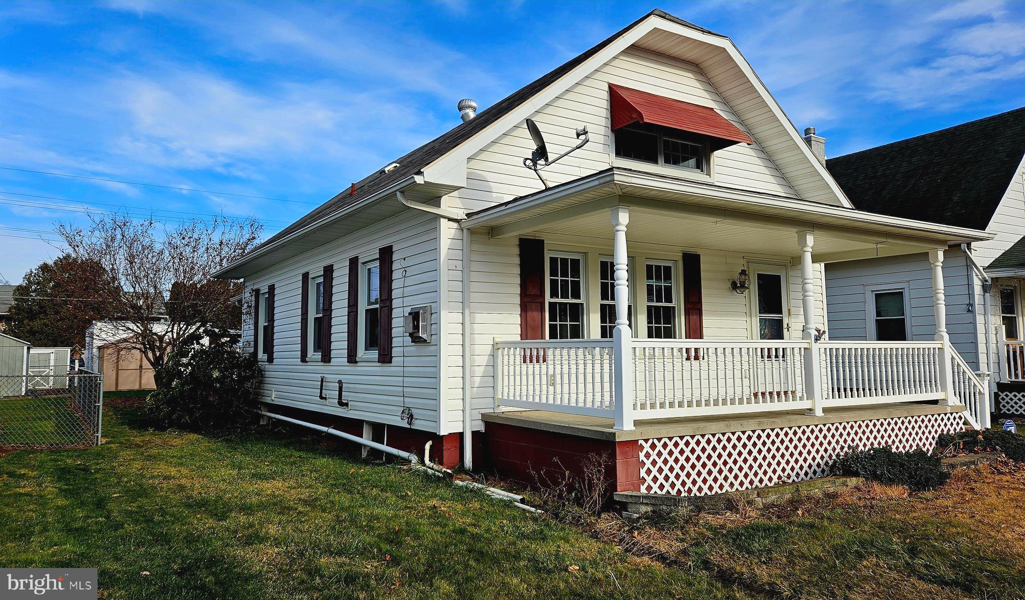 Attractive south side bungalow with many updates, both exterior & interior.  Vinyl siding, and vinyl porch railing for a low maintenance clean finished touch on both front & rear concrete covered porchs.  Replacement windows and cozy propane fireplace in the living room.  Spacious living room & dining area layout allows for large table if desired.  Kitchen has been remodeled with updated counter tops & cabinetry.  Main floor bedroom & full bath - 2 bedrooms on 2nd floor.   Not only is there off-street parking, but property has a 1 car detached garage AND 2 carports - up to 4 covered parking spot plus shed for additional storage.  200 amp service.  Just minutes from downtown attractions, grocery store, restaurants & schools.