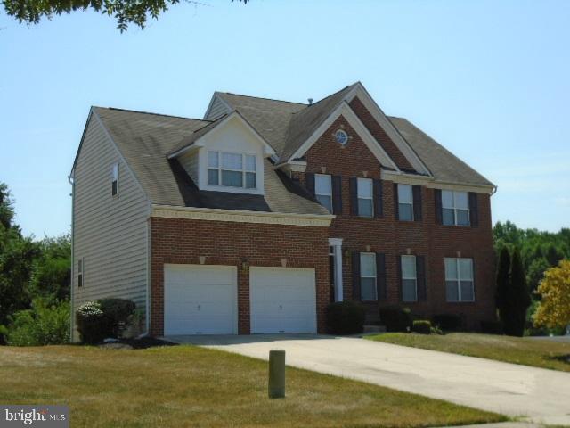 Brick front, 2-car garage, deck.
