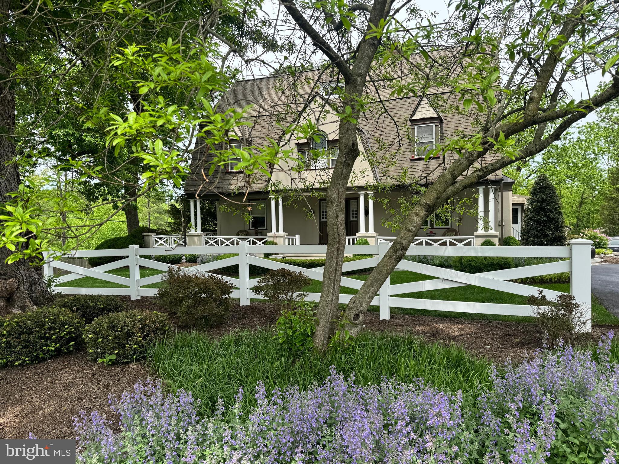 Charming 3-story, 6 Bedroom, 3 Full Bath Dutch Colonial Revival with over 3700 sq ft, featuring a signature gambrel roof, columned full-width wrap-around porch and charming Victorian accents, situated on a gorgeous 2.2 acre lot with fenced in-ground pool in the heart of Gwynedd Valley. Original details, intricate woodwork, 9' ceilings, gorgeous hardwood floors thru-out and thoughtful craftsmanship create a sense of authenticity and charm that is simply irreplaceable. A circular drive enveloped by professionally landscaped mature trees and shrubbery leads to the bluestone front walkway. The Entrance Hall with solid wood front door features the 1st of 2 staircases leading to the 2nd floor. Relax in the lovely Living Room featuring a wood-burning fireplace with brick surround and brick hearth, a bay window with window seat, and an inviting Breakfast Nook located between the Kitchen & Living Room, featuring French doors opening to the covered Porch. The outstanding, completely renovated Kitchen can be entered either from the Breakfast Nook or from double French doors in the entrance Hall, providing an ideal flow for entertaining. A chef’s delight awaits in the Kitchen with decorative tiled floor, marble counters, breakfast bar with wood counter and seating for 2, stainless farm sink with dishwasher, custom cabinetry, stainless Bosch dishwasher, 6-burner Thermador stove with custom hood, tiled backsplash, stainless Thermador wall oven with warming drawer and microwave, Subzero refrigerator, and decorative wood shelves. A separate “Prep” area offers a stainless sink, double subzero freezer drawers, wine rack, custom millwork marble counter and pantry closet.  Enjoy special meals in the spacious Formal Dining Room, experiencing the warmth of the 2nd  wood-burning fireplace w/brick surround and brick hearth and the 2nd window seat. An enclosed Vestibule adjacent to the Kitchen provides an alternative entrance to the house from the driveway & features a reclaimed wood bench, decorative tiled floor & coat hooks. 2 sets of stairs lead to the 2nd floor including one staircase in the Entrance Hall & one from the Kitchen. The 2nd Floor hall leads to 4 bedrooms.  The Main Bedroom with dormer window & ceiling fan connects to the Main Full Bath with tiled floor, soaking tub with shower w/sliding glass doors, furniture-style vanity w/vessel sink and built-in cabinetry with glass cabinets and drawers. The 2nd Bedroom, which is connected to the Main Bedroom can also serve as a Sitting Room or Office. Bedrooms 3 & 4 are served by the renovated beautiful Full Hall Bath with radiant-heated tiled floor, stall shower with frameless glass door and 2 shower heads, and a furniture-style vanity with vessel sink. 2 additional Bedrooms & a Full Hall Bath with stand-alone tub w/shower & built-in cabinetry are located on the 3rd floor.  The 2-Car Garage provides 2 automatic doors and a vaulted ceiling with storage above. Step outside and discover your own private retreat. The expansive grounds offer both beauty and tranquility, with mature landscaping & open space perfect for relaxation or recreation. A bluestone Patio is located adjacent to the side entrance. The fully-fenced in-ground Pool and heated Spa adds a resort-like touch, making summer days unforgettable and providing the perfect setting for entertaining family and friends. Other special features include a whole-house generator, 2 sheds, raised panel doors with glass knobs, oil-fired radiant heat & high velocity central air. This special Gwynedd Valley location, within highly rated Wissahickon School District, is within walking distance to the train to center city & also provides access to the Green Ribbon trail adjacent to the property. It is also close to the charming town of Ambler with 1st run movie theater, restaurants & boutique shops. Don’t miss the opportunity to own a home where enduring historic charm lives in every corner & possibilities are as expansive as the grounds themselves.