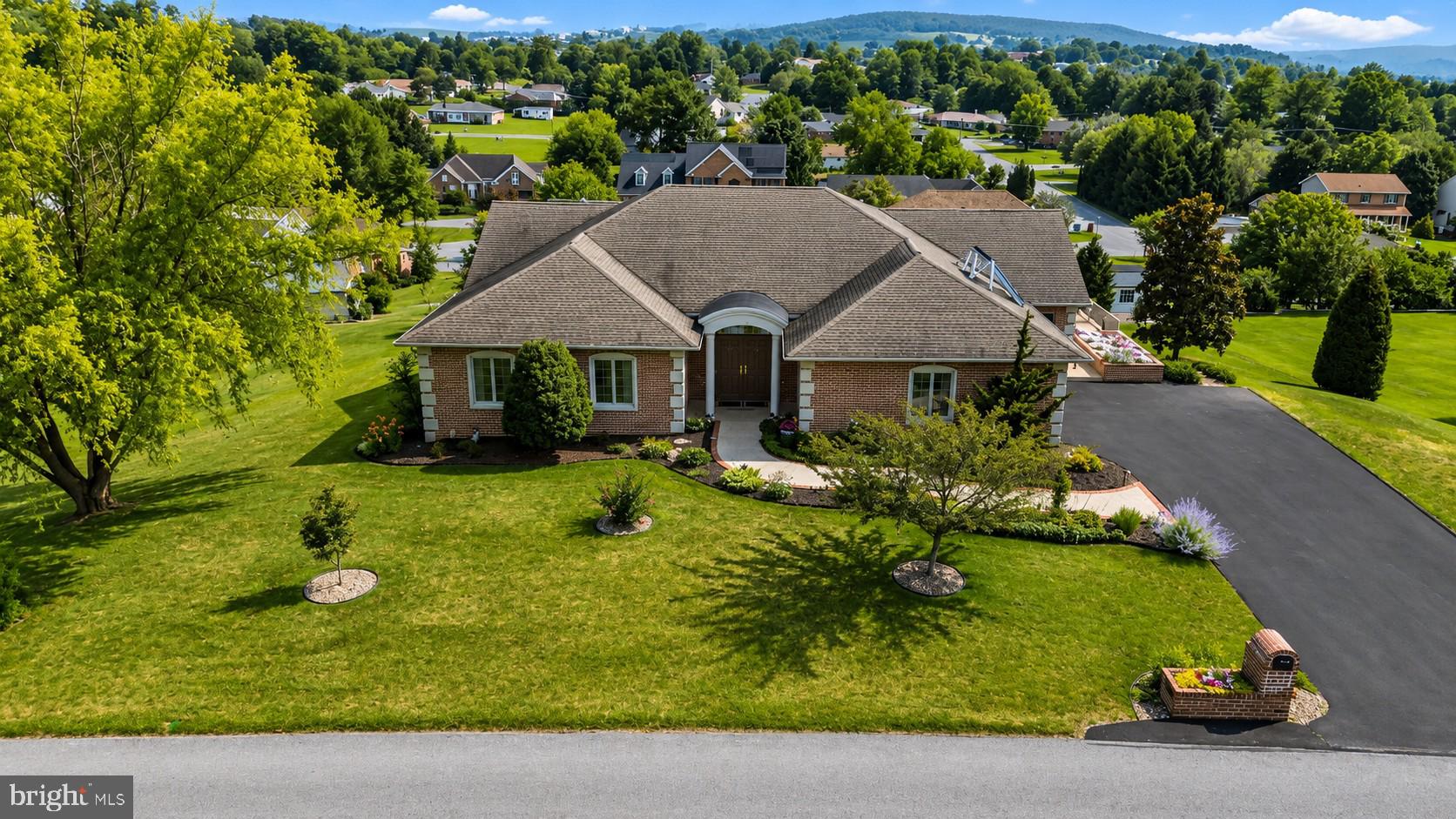 This exceptional one-owner, custom-built brick home has been lovingly cared for and meticulously maintained since the day it was built. From the moment you step inside, you'll appreciate the quality craftsmanship, thoughtful design, and custom appointments that set this home apart. Every detail was carefully selected, creating a home that is both elegant and comfortable.

Rich hardwood flooring, custom cherry cabinetry by Hess Cabinets, Corian countertops, pull-out cabinet drawers, a walk-in pantry, Andersen windows and doors, and numerous built-ins showcase the attention to detail throughout. Soaring 12' foot ceilings and an abundance of windows fill the home with natural light, creating a bright, spacious, and open floor plan that is both welcoming and ideal for everyday living or entertaining.

The thoughtfully designed main-level laundry offers additional cabinetry, hanging space, and a utility sink, while the primary suite features generous closet space, including a cedar-lined closet. The finished walkout lower level provides exceptional flexibility with plenty of room for entertaining, guests, hobbies, or multigenerational living.

Step outside onto the expansive wraparound deck, where you'll enjoy breathtaking panoramic mountain views that stretch for miles. Whether you're hosting family and friends or simply relaxing with your morning coffee, the setting is truly spectacular. Beautiful landscaping and mature trees further enhance the peaceful surroundings, making this property feel like your own private retreat.

Additional features include gas heating, solar hot water, central vacuum, a security system, an oversized side-entry garage and abundant storage, and countless custom upgrades throughout. Conveniently located just minutes from downtown Waynesboro, shopping, dining, and Interstate 81, this is a rare opportunity to own a home where exceptional craftsmanship, timeless quality, and meticulous care are evident at every turn.