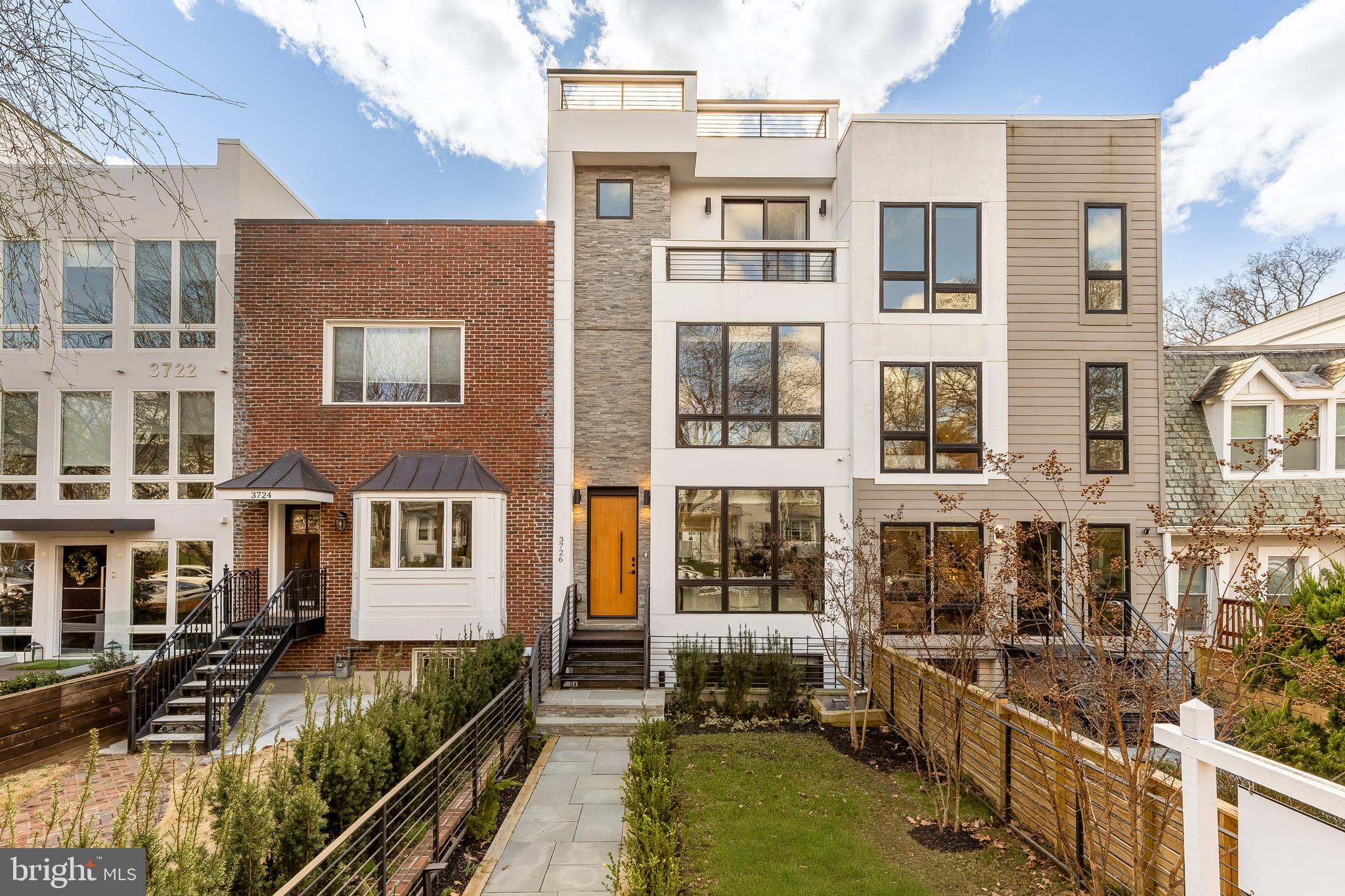 Tucked into the heart of Burleith, 3726 R Street NW offers the rare opportunity to own a contemporary residence with over 4,100 square feet of thoughtfully designed living space in one of Washington’s most desirable locations. Built in 2023 and enhanced with custom upgrades throughout, this five bedroom, five and one half bathroom home blends architectural sophistication with everyday comfort. Wide plank white oak floors, oversized black framed windows, a floating staircase with steel detailing, and an elevator servicing all levels create a polished and seamless living experience from the moment you step inside.

If you love the energy of Georgetown but crave the space and ease of a modern home, this is the balance you have been waiting for. Here, you enjoy a refined contemporary aesthetic, open sightlines, and curated finishes that go far beyond builder grade. The Italian Scavolini kitchen with marble surfaces and a full suite of Monogram appliances anchors the main level, while floor to ceiling sliding doors connect indoor and outdoor living with ease.

Four fully finished levels provide remarkable flexibility. Each bedroom features its own en suite bath, including a serene primary suite with a private balcony and spa inspired bath. The lower level offers a recreation room, wine cellar, wet bar, and guest suite. Above it all, an expansive rooftop terrace spans the length of the home and offers sweeping views, ideal for entertaining or unwinding at the end of the day. A detached two car garage adds convenience rarely found in this location.

Living in Burleith means enjoying a peaceful residential setting just moments from Georgetown’s shops and restaurants along M Street and Wisconsin Avenue. Nearby trails in Glover Archbold Park and the C&O Canal Towpath offer easy access to nature. It is a lifestyle that pairs walkability, green space, and modern luxury in one exceptional address.