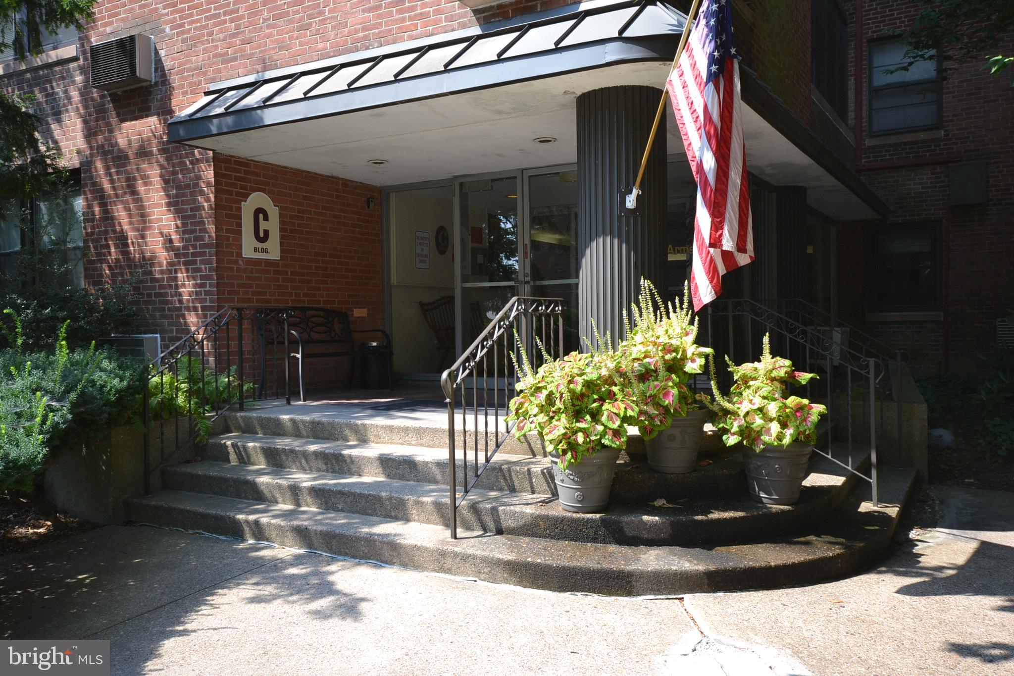 Rare opportunity to own a spacious 2-bedroom condominium in the highly sought-after Wildman Arms community. This bright and welcoming unit offers a flexible floor plan with grand living and dining areas, a sunny enclosed porch, and additional space ideal for a home office, reading nook, or hobby area. The handsome updated kitchen features white shaker cabinetry, quartz countertops, tile backsplash and stainless steel appliances. An all-in-one washer/dryer unit—a rare amenity at Wildman Arms—adds everyday convenience. The ceramic tile hall bathroom features a tub/shower combination, while both generously sized bedrooms offer ceiling fans and ample closet space. Wildman Arms residents enjoy a beautiful swimming pool, individual garden plots, a game room, exercise room, and community library, all included in the monthly fee. Additional storage and indoor parking are available for nominal fees. Ideally situated in the heart of Lansdowne, you'll be just a short stroll from the recently beautifully restored Lansdowne Theater, Backstage Tap & Grill, the SEPTA Regional Rail Station, shopping, the Lansdowne Farmers Market, Library, and other neighborhood attractions. Lansdowne is a vibrant historic community known for its thriving arts scene, year-round events, and convenient access to Center City Philadelphia and Philadelphia International Airport. A wonderful opportunity to enjoy the character, amenities, and walkable lifestyle that make Wildman Arms Lansdowne's most desirable condominium community.