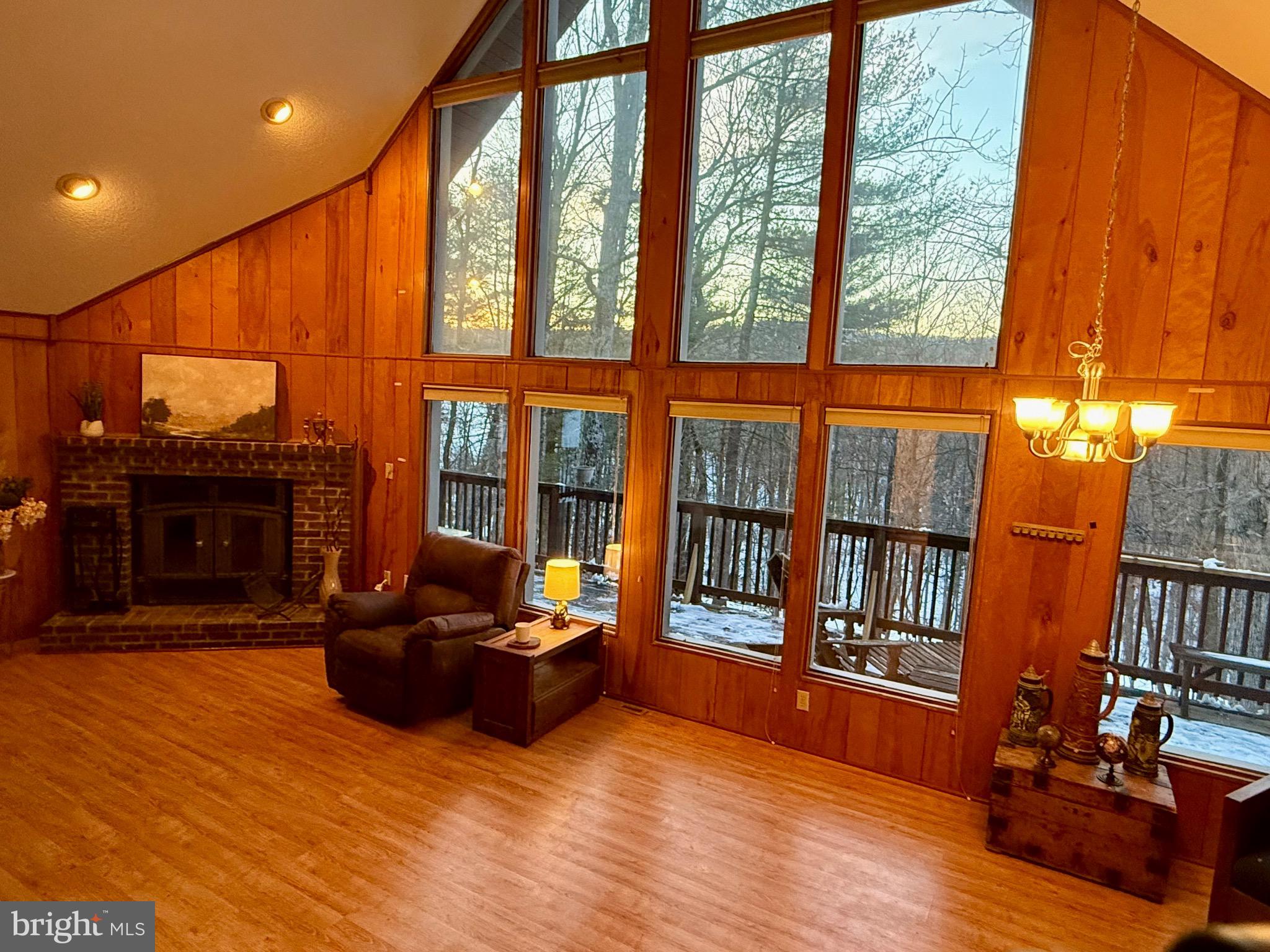 **Please submit your highest & best offer by Monday 2/17 at 3pm.**
Welcome to your dream retreat in Hedgesville, WV, nestled in a peaceful, amenity-rich community. This stunning 3-bedroom, 2-bathroom home offers the perfect balance of comfort and nature, whether you’re seeking a full-time residence or a serene vacation getaway. Situated on a wooded lot, the home features a detached 2-car garage and is designed to showcase its natural surroundings with a wall of windows that bring the beauty of the woods right into your living space. Step outside onto the large deck or screened porch, perfect for sipping your morning coffee or unwinding after a long day. Inside, the expansive great room with a soaring cathedral ceiling and cozy wood-burning fireplace creates an inviting, airy atmosphere that is sure to impress. Just 90 minutes from both Washington, D.C., and Baltimore, you’re close enough to city life while still enjoying the peace and tranquility of the country.

This property includes a Class A membership, granting access to an exceptional range of amenities for an initial transfer fee of $3,150 and an annual fee of $2,756. Membership provides access to two 18-hole championship golf courses, a driving range, chipping green, and putting green, as well as 2 outdoor pools, 1 indoor pool, and a hot tub. Fitness enthusiasts will appreciate the fully equipped fitness center and sports complex, which features indoor and outdoor tennis, pickleball, racquetball, volleyball, basketball, and a multi-use court, along with a softball field, sauna, and steam room. Enjoy catch-and-release fishing in Waldon Pond and Sylvan Lake, or relax in the member’s lending library and meeting room. After a day of recreation, you can unwind at the Sleepy Creek Spa or dine at the Clubhouse Grille & Pub (temporarily closed). Outdoor lovers will also enjoy direct access to the 23,000-acre Sleepy Creek Wildlife Management Area, which offers 75 miles of hiking trails and fishing at its 205-acre lake.

The HOA fee of $67 per month covers common area maintenance, road upkeep, snow removal, and trash services, and the home is within walking distance of the clubhouse, pro shop, driving range, and outdoor pool. This property offers more than just a home—it’s a lifestyle. Schedule your showing today and experience everything this incredible community has to offer!