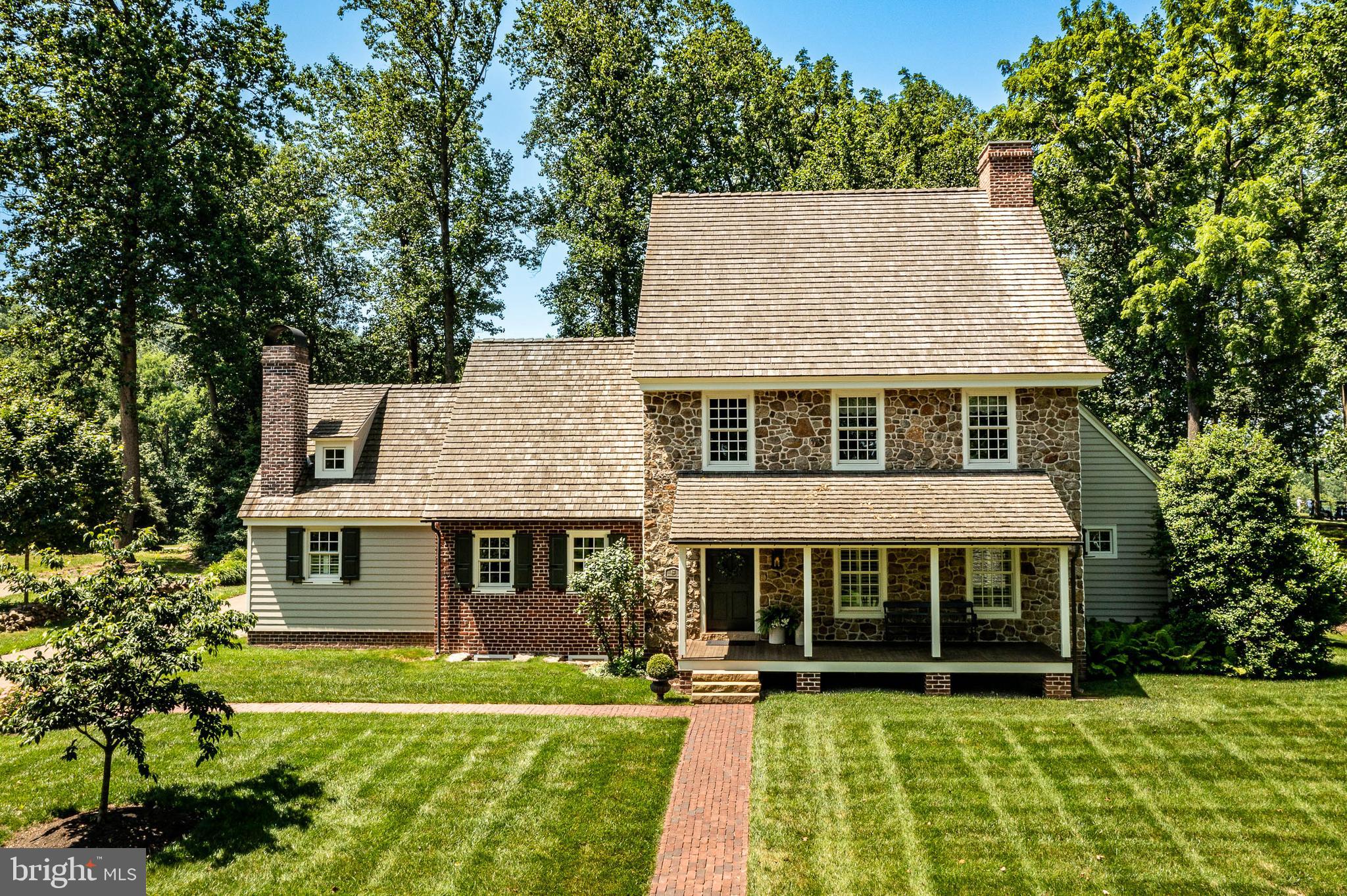 Set in the picturesque Olde Bulltown Village and overlooking the 14th hole of the French Creek Golf Club, sits this stunningly gorgeous  three bedroom, two full, two half bath home. Loaded with the custom touches of master builder Stoltzfus, this home has been expertly designed and immaculately maintained. Constructed to resemble an antique house, the home has loads of contemporary features like cathedral ceilings, a first floor master suite and a finished Lower Level. The Entry combines the old and the new with a cathedral ceiling, a raised panel entry door with strap hinges and an antique Carpenter box lock, beautiful quarter sawn oak floor, and a well crafted staircase leading to the Upper Level. Along the way to the expansive Great Room, you will pass a handy Powder Room on the left and the access to the Primary Suite on the right. The Great Room’s soaring ceiling is faced with beaded boards and the west facing windows offer long views, perfect for enjoying colorful sun sets. The cozy gas fireplace features a flat arch, stone hearth and a raised panel mantel. Doors leading to a Patio flank the fireplace. On the south wall is a Wet Bar with stunning custom cabinetry and a beverage cooler. Access to a Covered Porch with a brick floor and a ceiling fan is on the north wall. The inviting Dining Room features a stunning period chandelier and handsome crown molding. A pocket door opens to the Kitchen which features beautiful cabinetry, high end appliances like a six burner Wolf stove with a griddle, Bosch dishwasher, and a Viking Refrigerator. Like several rooms on this level the Kitchen also has a cathedral ceiling faced with beaded boards. Next to the Breakfast Area is a lovely corner gas fireplace with a raised panel mantel. Off a short hallway leading back to the Entry is the home’s Laundry and an access door which takes you to the Two Car Garage. The primary Suite features a large carpeted Bedroom and a Dressing Room with loads of custom cabinets capable of accommodating the largest of wardrobes. The Bathroom is straight-out of a magazine! Two custom vanities, a Kohler soaking tub, gorgeous marble floor and wainscoting, and a large shower/commode closet with more beautiful marble walls and floor. At the top of the staircase leading to the Upper Level is an Office area with a banister offering views into the Great Room below. There is also access to attic storage on the south side of the room. On the north side are found two Bedrooms and a Bathroom with lovely cabinets. The Lower Level features a large carpeted Family Room with a gas fireplace and a Wet Bar with an under-the-counter refrigerator. This is the perfect spot of inviting friends and family over to enjoy the big game! Off the Family Room is a spacious Game Room - the ideal site for the pool table. Also found on this level is a second Powder Room. Additionally, there are two large unfinished rooms that house the home’s utilities including a geothermal heat pump. Unique for such a quiet setting, the property has public utilities. East Nantmeal Township is well known for its commitment to protecting open space and offers a wonderful lifestyle. For the golfer, in addition to French Creek, there are two other courses close by: Stonewall and Honey Brook. Rarely does a home of this quality boasting these amenities come on the market at such an attractive price.