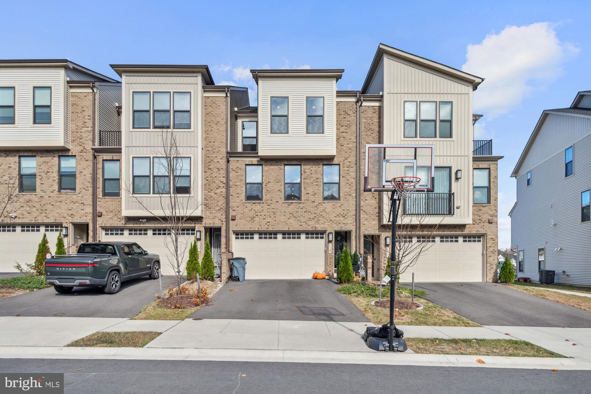 Welcome to this meticulously maintained, modern townhome in the sought-after Cedar Creek community. At just two years old, this like-new home blends luxury with contemporary design. Step inside to a bright, welcoming foyer with upgraded porcelain tile leading to a large 2 car garage and a versatile flex space ideal for an office or studio. From here, enjoy direct access to your own private fenced-in yard, complete with a custom stone patio for outdoor relaxation. Take the oak staircase to the open-concept living area, where the gourmet kitchen takes center stage. With elegant Calcutta Quartz countertops, an oversized island, and upgraded pendant lighting, this kitchen is both beautiful and functional, offering the perfect setting for preparing meals or entertaining guests. It flows seamlessly into the inviting family room and a fully finished porch that extends the living space and offers even more room to entertain. Upstairs, discover three generously sized bedrooms and two full bathrooms, each designed with comfort in mind. The convenience of a laundry room on this level adds to the home’s practicality. The primary suite feels like a private retreat, featuring coffered ceilings, a spacious walk-in closet, and a luxurious bathroom with upgraded tile and fixtures. Cedar Creek offers a wealth of amenities, including jogging and biking trails, playgrounds, and beautifully landscaped common areas. With the shops, dining, and entertainment options of River Hill and Clarksville just minutes away, this home offers the perfect combination of luxury and convenience.