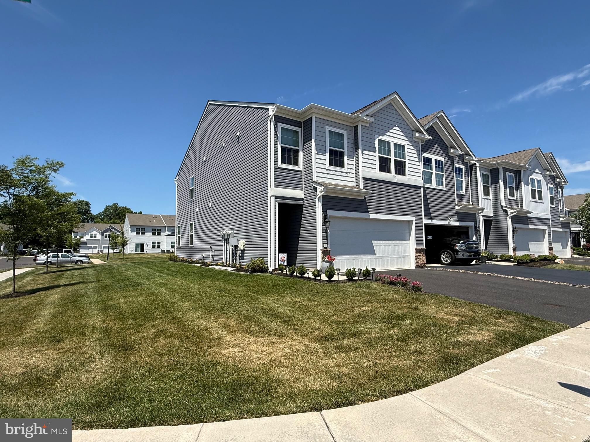 Welcome to Fonthill, a charming townhome community that offers the privacy of a small neighborhood while providing convenient access to Route 309, shopping, dining, and everyday amenities. This newly built luxury end-unit townhome combines low-maintenance living with modern style and functionality. The main level features an open-concept floor plan with soaring ceilings, creating a bright and spacious atmosphere ideal for both everyday living and entertaining. The gourmet kitchen boasts quartz countertops, stainless steel appliances, abundant cabinet storage, and an oversized island with seating for four. The kitchen flows seamlessly into the dining and living areas, making gatherings effortless. 
Upstairs, you'll find four generously sized bedrooms, a spacious foyer, and a convenient second-floor laundry area. All bedrooms are equipped with ceiling fan wiring. The primary suite offers a walk-in closet and a private en-suite bath featuring dual vanities. Three additional bedrooms and a full hall bath complete the second floor.  As an end unit, this home enjoys additional green space, enhanced natural light, and a private rear patio—perfect for relaxing outdoors.  Don't miss this exceptional opportunity to own a beautifully appointed home in the desirable Fonthill community. Open House: Sunday, June 14, 2026, from 1:00 PM to 3:00 PM.