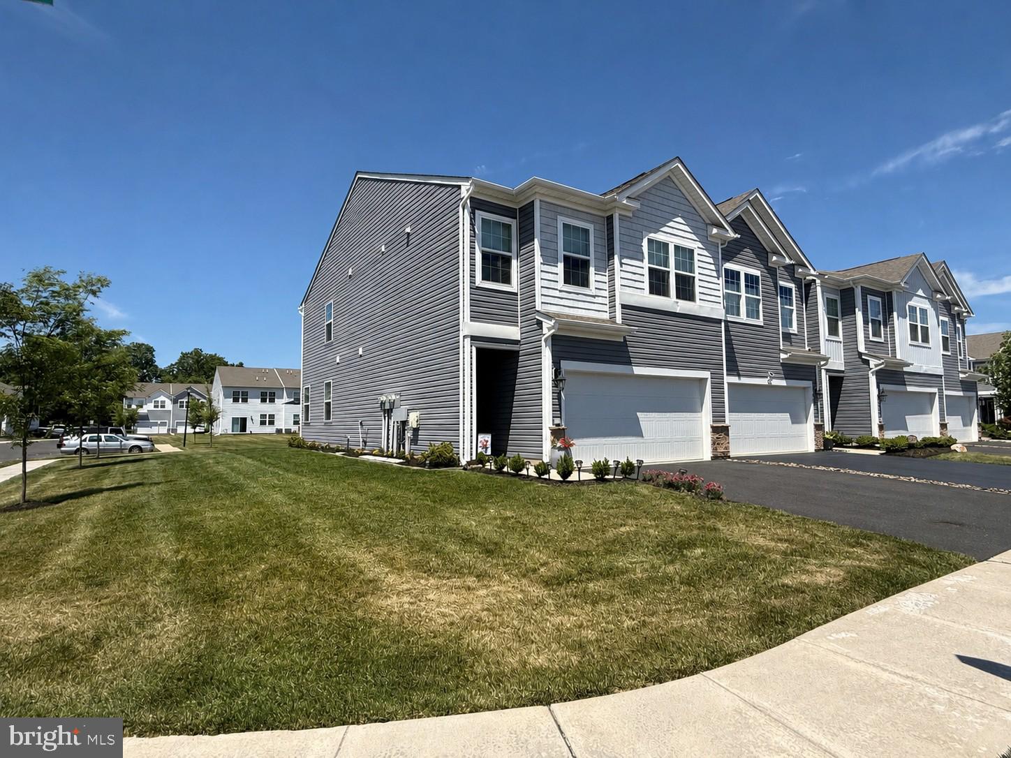 Welcome to Fonthill, a charming townhome community that offers the privacy of a small neighborhood while providing convenient access to Route 309, shopping, dining, and everyday amenities. This newly built luxury end-unit townhome combines low-maintenance living with modern style and functionality. The main level features an open-concept floor plan with soaring ceilings, creating a bright and spacious atmosphere ideal for both everyday living and entertaining. The gourmet kitchen boasts quartz countertops, stainless steel appliances, abundant cabinet storage, and an oversized island with seating for four. The kitchen flows seamlessly into the dining and living areas, making gatherings effortless. 
Upstairs, you'll find four generously sized bedrooms, a spacious foyer, and a convenient second-floor laundry area. All bedrooms are equipped with ceiling fan wiring. The primary suite offers a walk-in closet and a private en-suite bath featuring dual vanities. Three additional bedrooms and a full hall bath complete the second floor.  As an end unit, this home enjoys additional green space, enhanced natural light, and a private rear patio—perfect for relaxing outdoors.  Don't miss this exceptional opportunity to own a beautifully appointed home in the desirable Fonthill community. Open House: Sunday, June 14, 2026, from 1:00 PM to 3:00 PM.