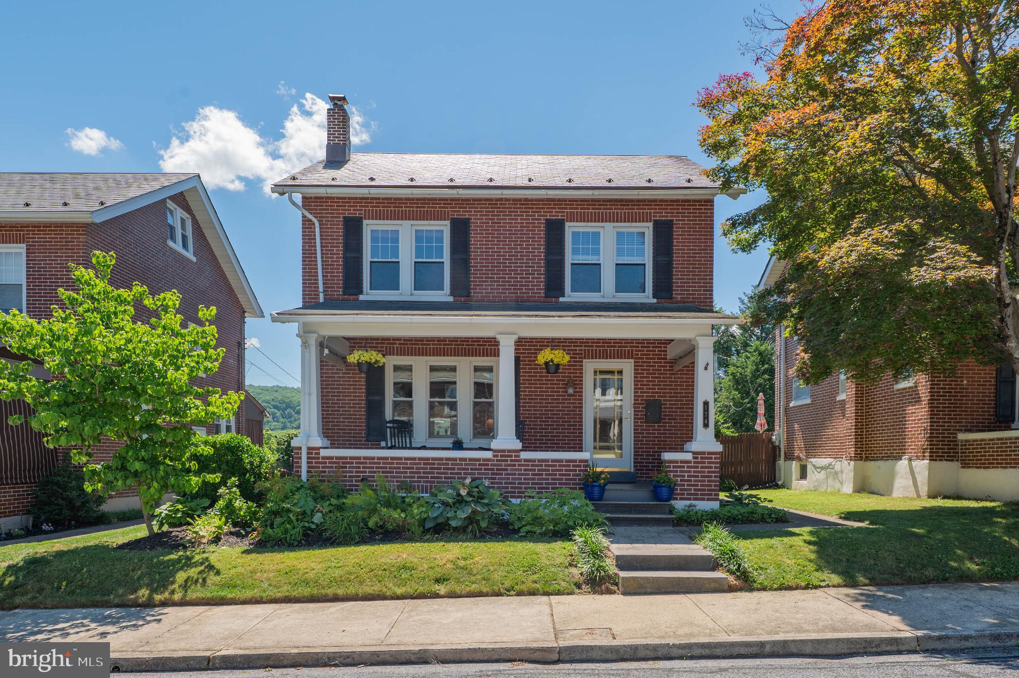 This meticulously maintained 4-bedroom, 2-bath brick home in desirable East Penn School District offers comfort, character, and functionality throughout. From the charming covered front porch, enter the bright foyer to the living room flooded with natural light and inlaid hardwood floors. The sizable dining room is donned with wainscoting, gorgeous stained-glass window, gleaming hardwood, built-in shelving and opens to the kitchen where you can showcase your cooking skills. The extensive kitchen with counter seating, large pantry, stainless steel appliances, stone countertops and tile backsplash has both a bar area complete with sink and an apron front sink. Step outside to delight in the covered rear porch, paver patio, mature landscaping, and fenced-in private backyard with tremendous views of South Mountain, ideal for entertaining and relaxing. The first floor also includes a sunlit family room and a full bath, providing an easy conversion to a bedroom suite. On the second floor, you'll find three bedrooms with adequate closet space and a spacious second full bath. The third floor is fully finished and provides great space for another bedroom, playroom, office, or rec room. The partial finished lower level with recessed lighting offers versatile space for an additional family room or rec area, plus a bonus area with laundry and plenty of storage. With five brand-new mini-split units for heating and cooling, a newer roof, detached garage, and parking pad, this home has it all. Located in the Emmaus Borough, you'll enjoy a quiet neighborhood with shops, restaurants, farmer's market, schools, and parks all within walking distance. Don't miss this move-in-ready home; schedule your showing today!