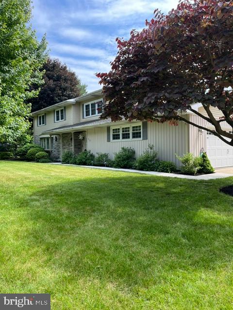 Large 4 bedroom 2.5 bath home with a large yard. Featuring central air, heated sunroom, fireplaces, heated garage, and a shed.  Two large storage rooms in the basement, plus partial finished room with a fireplace.