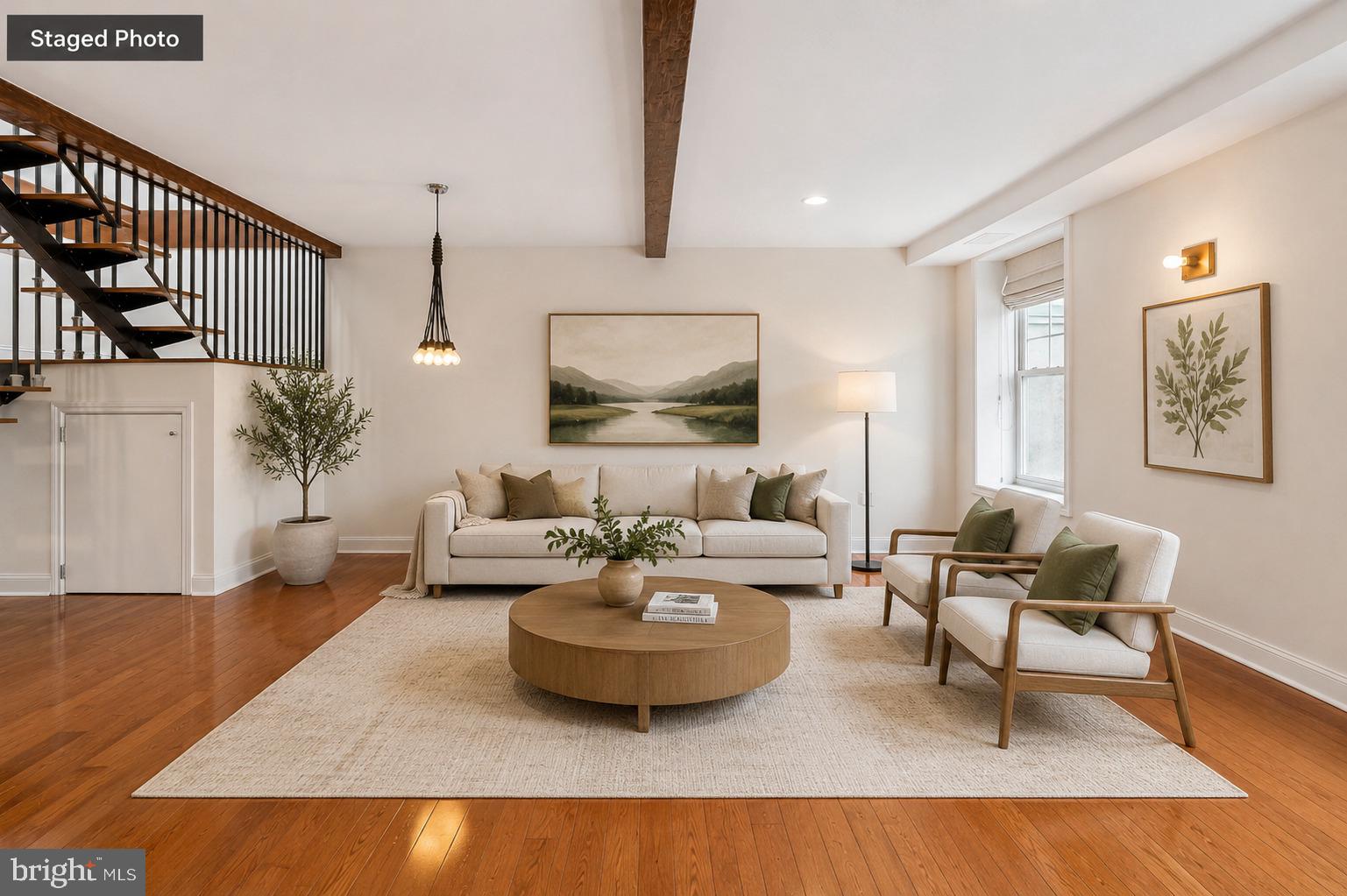 Sun-soaked and spacious, this stunning Callowhill condo offers over 1,700 square feet of open-concept living, soaring ceilings, and rare two-car gated parking.

Upon entering, you’re immediately drawn to a striking steel floating staircase that separates the kitchen from the living and dining areas while maintaining the home’s airy flow. Hardwood floors run throughout, complemented by stylish modern light fixtures.

The chef’s kitchen is outfitted with high-end stainless steel appliances, including a gas range, granite countertops, a sleek tile backsplash, abundant cabinetry, and a large island with breakfast bar seating — ideal for both everyday living and entertaining.

Flooded with natural light and south-facing views of the city skyline, the expansive living area offers multiple seating and entertaining zones. Exposed wooden beams and a gas-burning fireplace with custom built-ins add warmth, character, and charm. The first floor is completed by a half bathroom and a coat and storage closet.

Upstairs, the primary bedroom features a walk-in closet and an en-suite bathroom with a double vanity, standing shower, and large soaking tub. Two additional bedrooms, a full hall bath, and a dedicated laundry area with a full-size washer and dryer complete this level.

Additional highlights include a deeded large private storage room in the basement and a shared outdoor space for enjoying warmer weather. The unit has been thoughtfully prepared for the future addition of a private roof deck, offering the opportunity to create exceptional outdoor living space with stunning city views.

Perfectly situated just off Spring Garden Street, this home is steps from Prohibition Taproom, Café Lift, and Elixr Coffee, amongst many other excellent eateries. Grocery options including Trader Joe’s, Aldi, and Acme are nearby, along with easy access to Reading Terminal Market and Chinatown. With the Rail Park close by, quick access to the Broad Street Line, and Center City just a short walk away, this home seamlessly blends historic character with modern convenience in one of Philadelphia’s most dynamic neighborhoods.