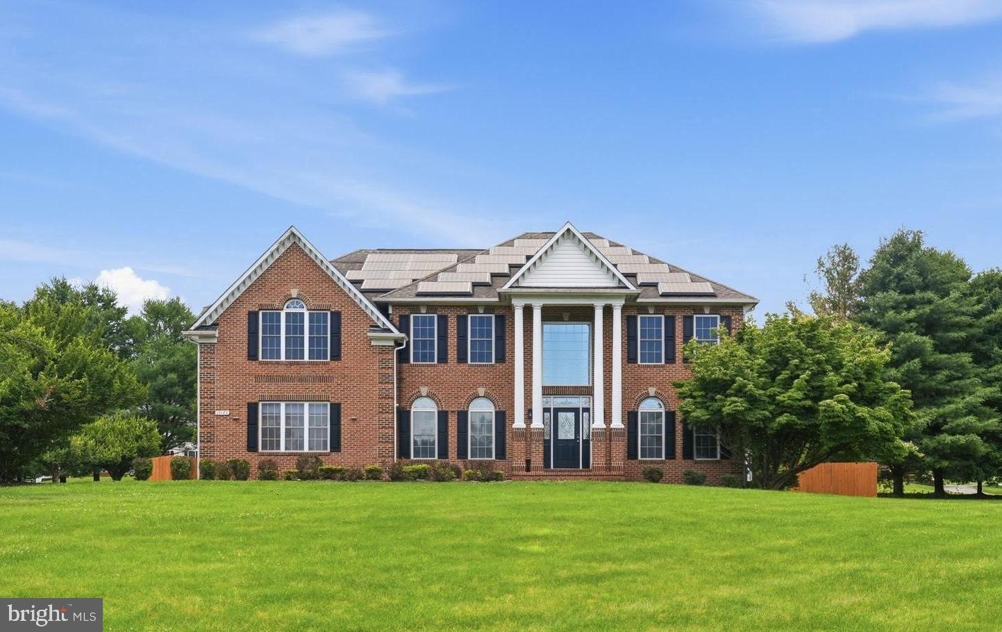 Welcome to this distinguished residence in the highly sought-after Woodfords Grant community of Marriottsville, where timeless elegance, expansive living areas, and an exceptional location come together to create a truly remarkable place to call home.

Situated on just over one acre of professionally maintained grounds, this impressive estate offers nearly 6,500 square feet of finished living space thoughtfully designed for both grand entertaining and everyday comfort. From the moment you arrive, the home's commanding presence and classic architecture set the tone for what awaits inside.

Designed with entertaining in mind, the gourmet kitchen serves as the heart of the home and offers a timeless blend of elegance and practicality. Granite countertops, stainless steel appliances, a spacious center island, abundant cabinetry, and a dedicated butler's pantry create a space equally suited for intimate family dinners and large-scale gatherings. Seamlessly connected to the surrounding living areas, the kitchen encourages conversation, connection, and memorable moments with family and friends.

A dramatic two-story great room serves as the centerpiece of the main level, where soaring ceilings and expansive windows create a breathtaking sense of openness and natural light. Just beyond, the sun-filled rear sunroom provides a tranquil retreat overlooking the backyard, while a dedicated main-level office offers the flexibility today's lifestyle demands.

Upstairs, the luxurious owner's suite serves as a private sanctuary, offering exceptional scale and functionality rarely found in today's homes. Three walk-in closets provide abundant storage and organization, while the expansive primary bath offers a spa-like experience complete with a soaking tub and oversized shower. Adding architectural character to the upper level, a charming Romeo and Juliet overlook provides a unique vantage point into the dramatic great room below, enhancing the home's open and connected design.

Generously sized secondary bedrooms provide comfortable accommodations for family and guests, while the fully finished lower level expands the home's versatility even further. Complete with a full bathroom and an additional flex room ideal for a guest suite, home gym, playroom, media room, hobby space, or second office, this level adapts effortlessly to a variety of lifestyle needs.

Step outside to enjoy the fully fenced rear yard, offering ample space for recreation, pets, gardening, or future outdoor living enhancements. The playground provides an inviting space for outdoor fun, while the nearby horse farm contributes to the area's picturesque setting and sense of openness, creating a peaceful backdrop that complements the property's estate-like feel.

Additional highlights include a two-car side-entry garage, abundant storage throughout, and an unbeatable location just minutes from dining, shopping, entertainment, golf, and convenient access to I-70.

Rarely does a home offer this combination of size, sophistication, versatility, and location. An exceptional opportunity to own one of Woodfords Grant's premier residences and experience the lifestyle that makes Marriottsville one of the area's most desirable places to call home.